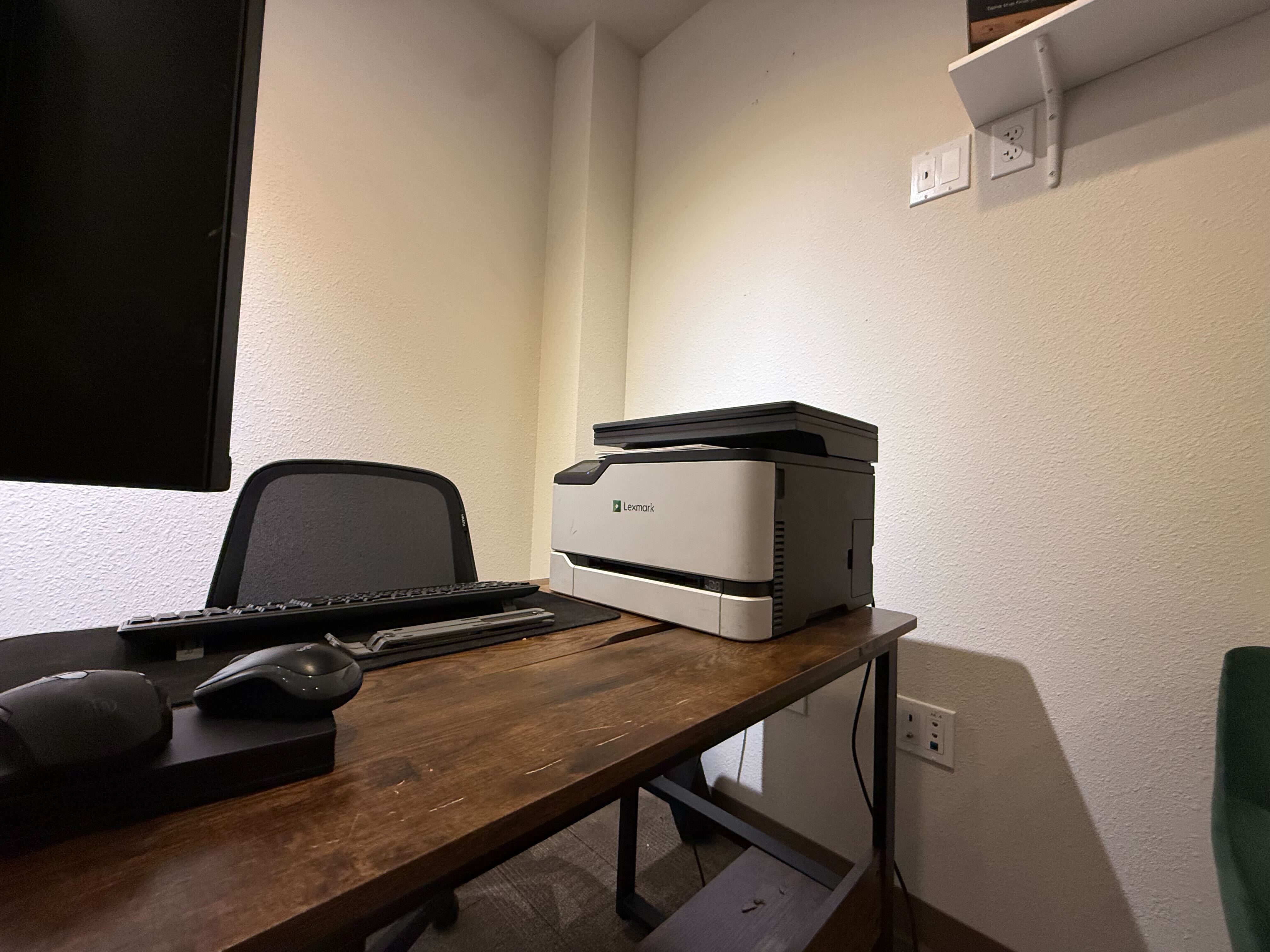 Close-up of desk with Lexmark printer and keyboard
