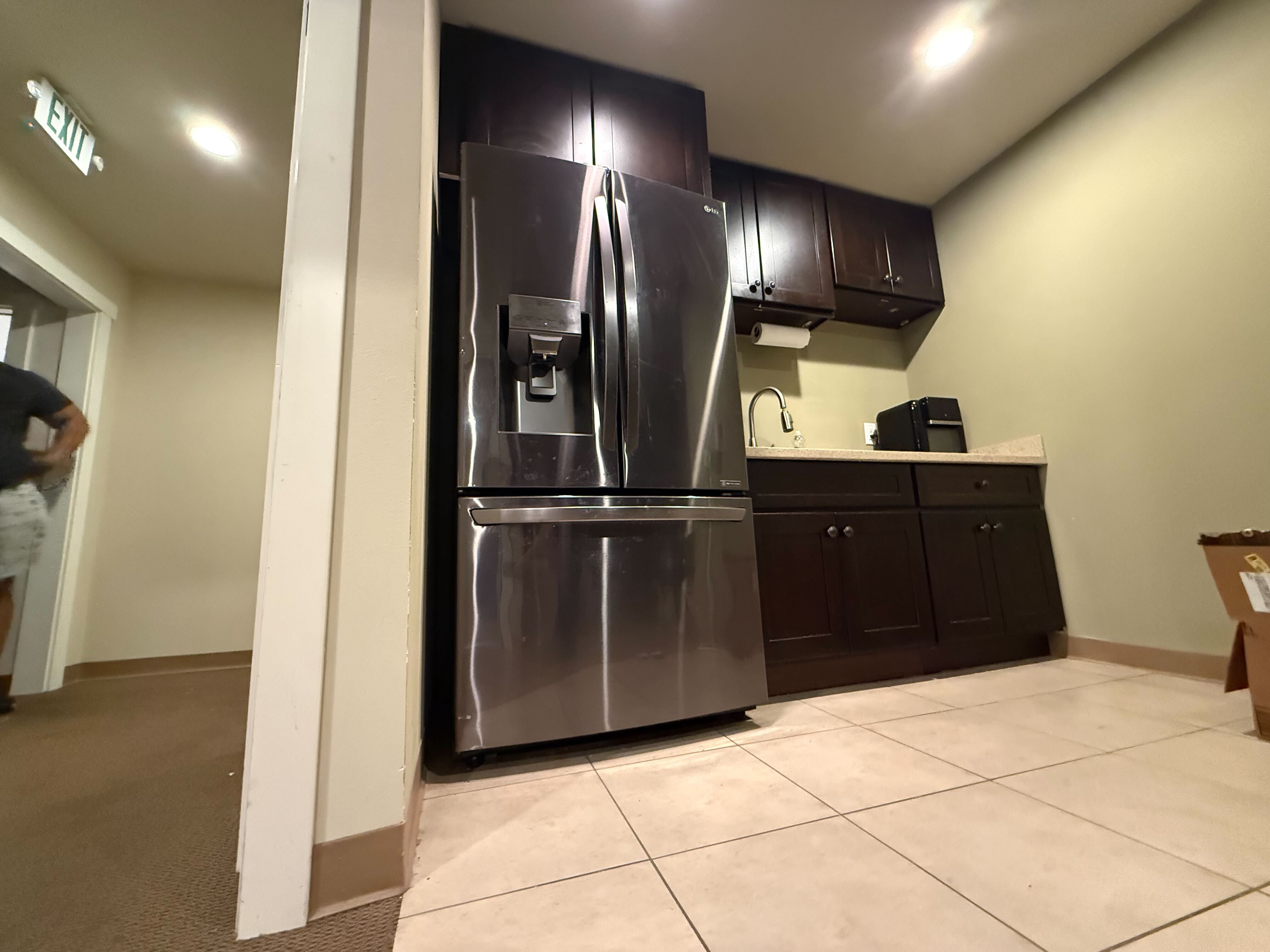 Kitchenette with refrigerator and appliances
