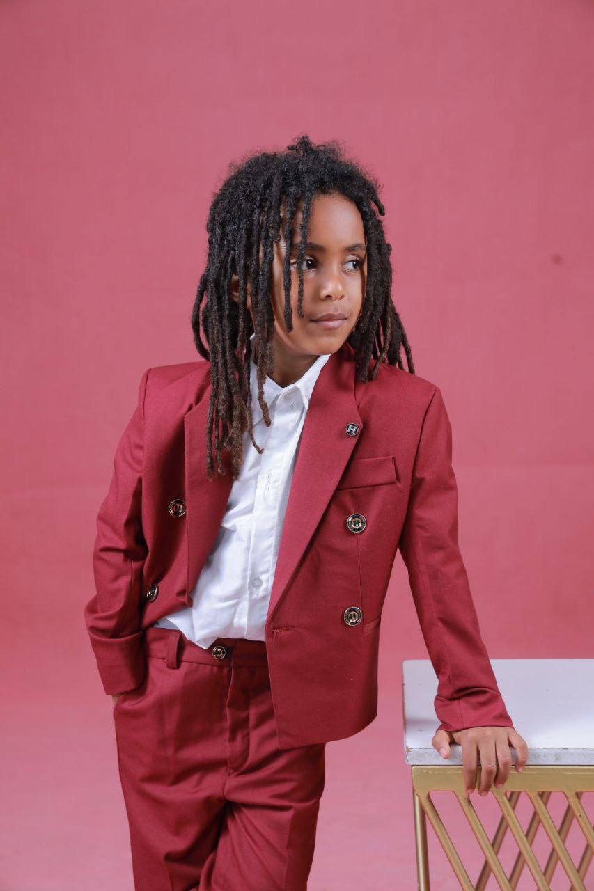 Model in a red suit against a pink background