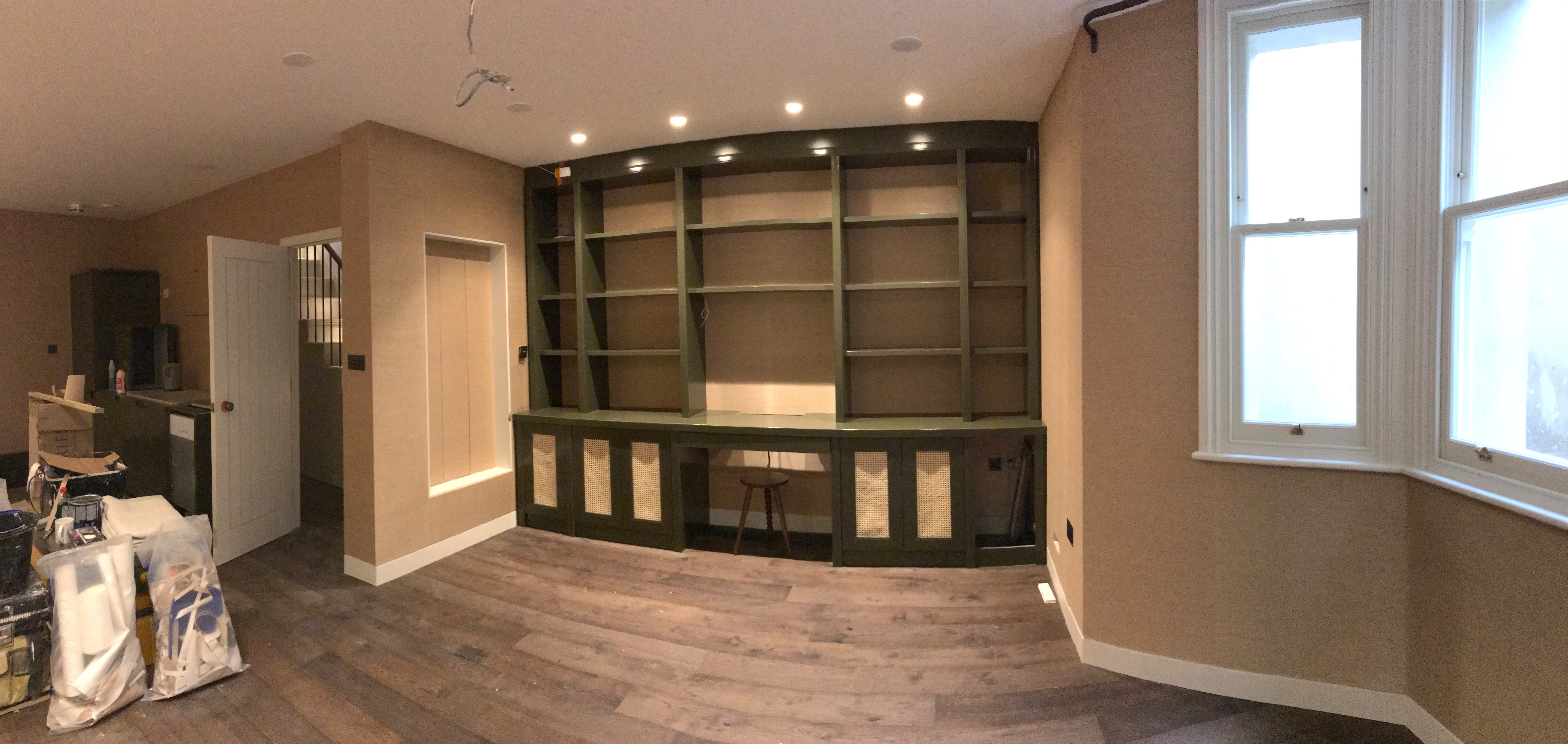 Completed room with blush pink wallcovering and green built-in