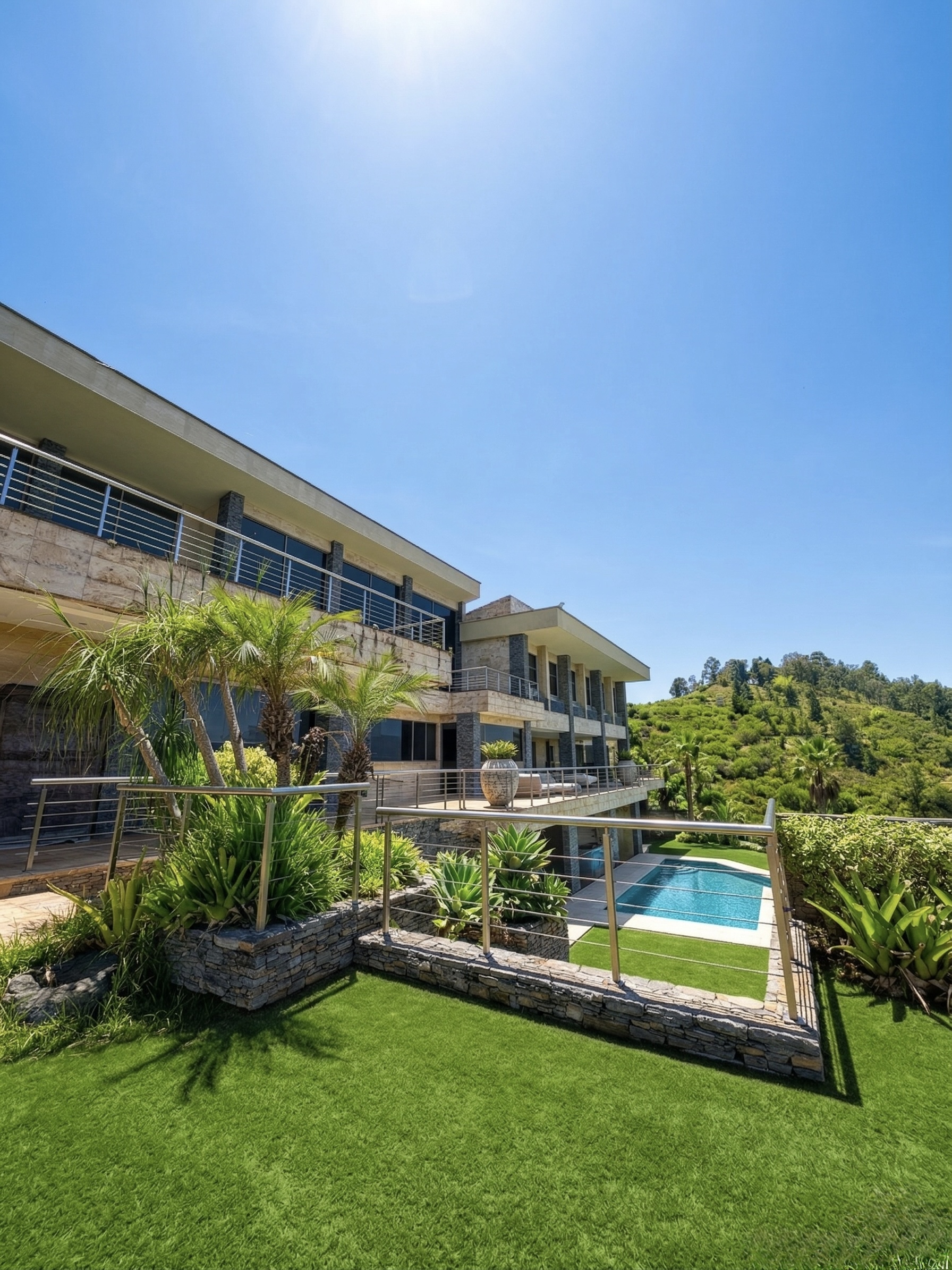 Exterior facade showing contemporary architecture with infinity pool, landscaped terraces and mountain backdrop, La Trinidad estate