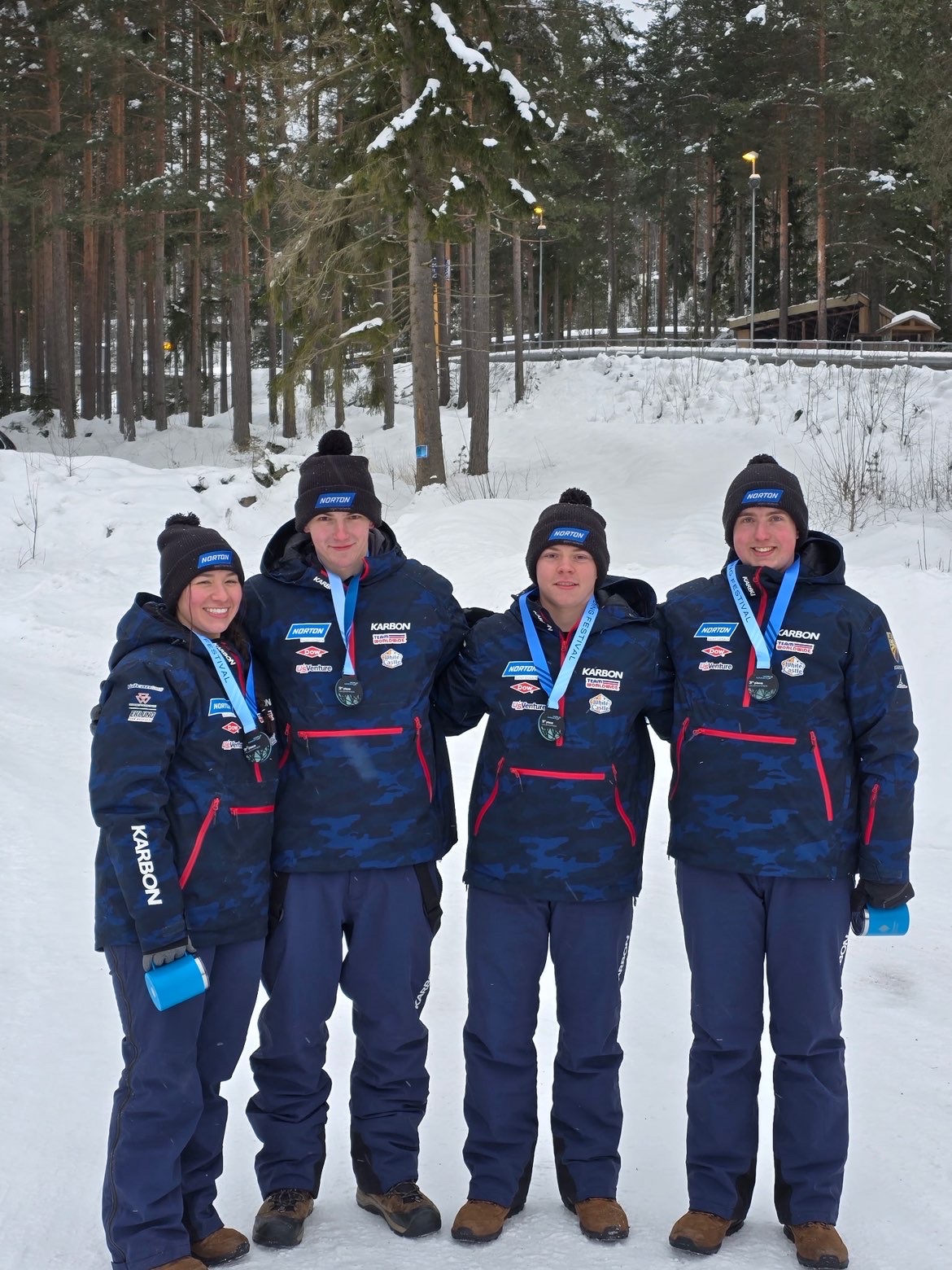 Logan with Team USA teammates at Junior Nationals, all wearing medals
