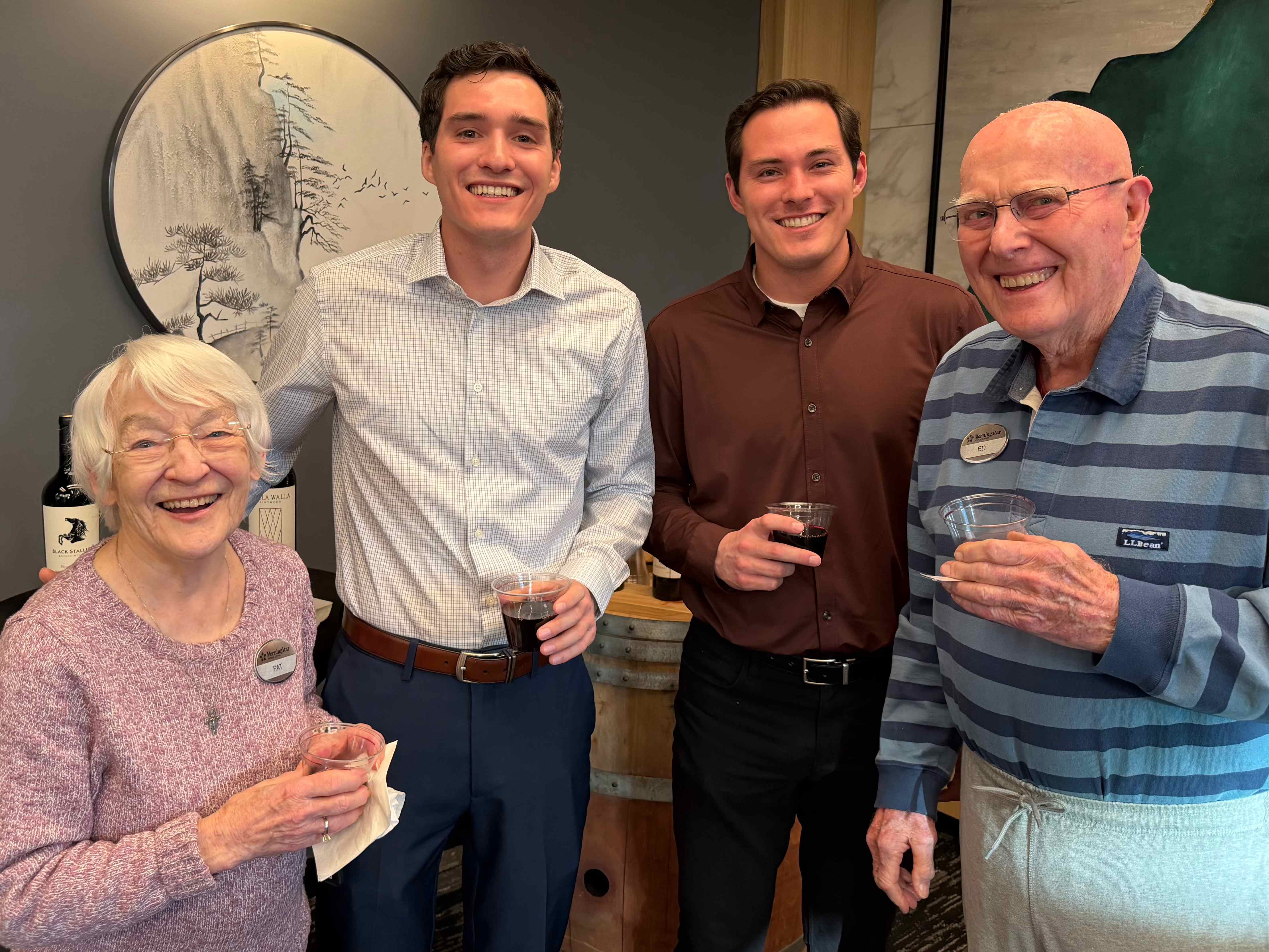 The Care Brothers and community members celebrating together, showing genuine intergenerational joy and connection