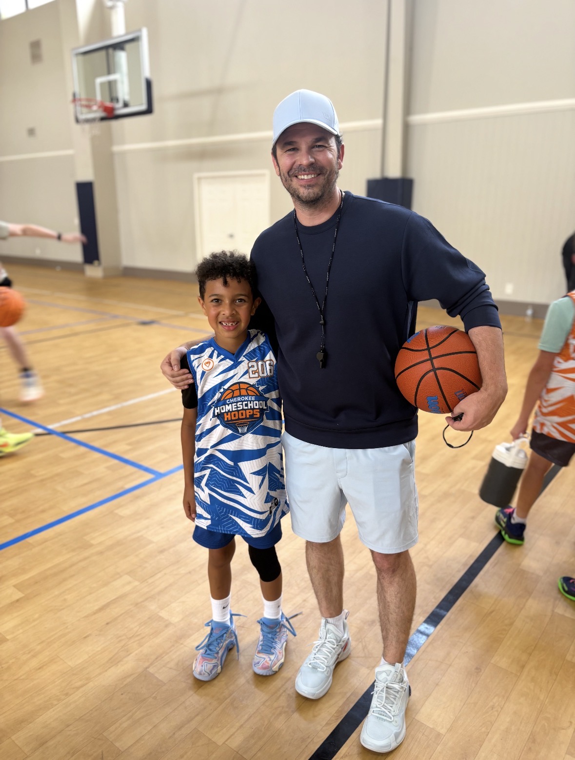 Coach Justin McTeer with a player on the Cherokee Homeschool Hoops court