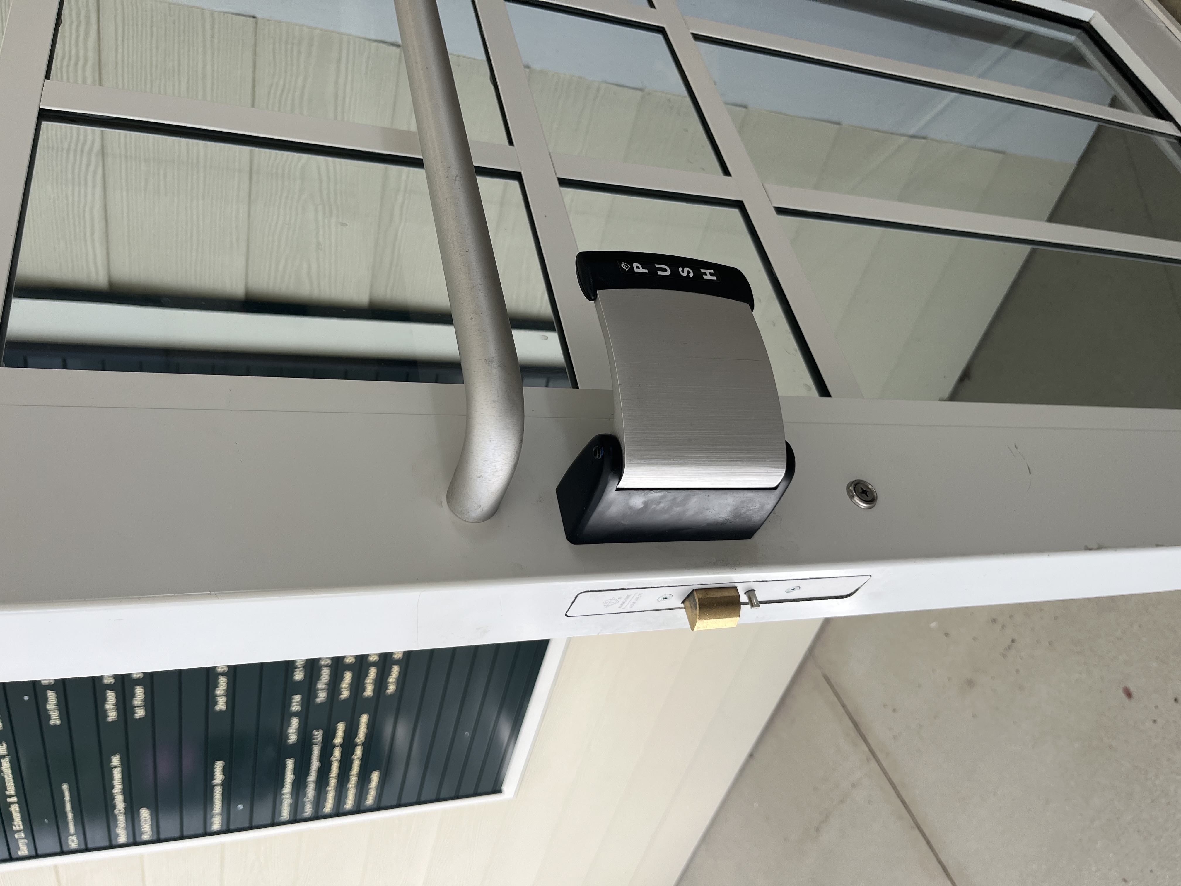 Commercial door interior: push-paddle panic bar for one-touch emergency egress, Sarasota FL