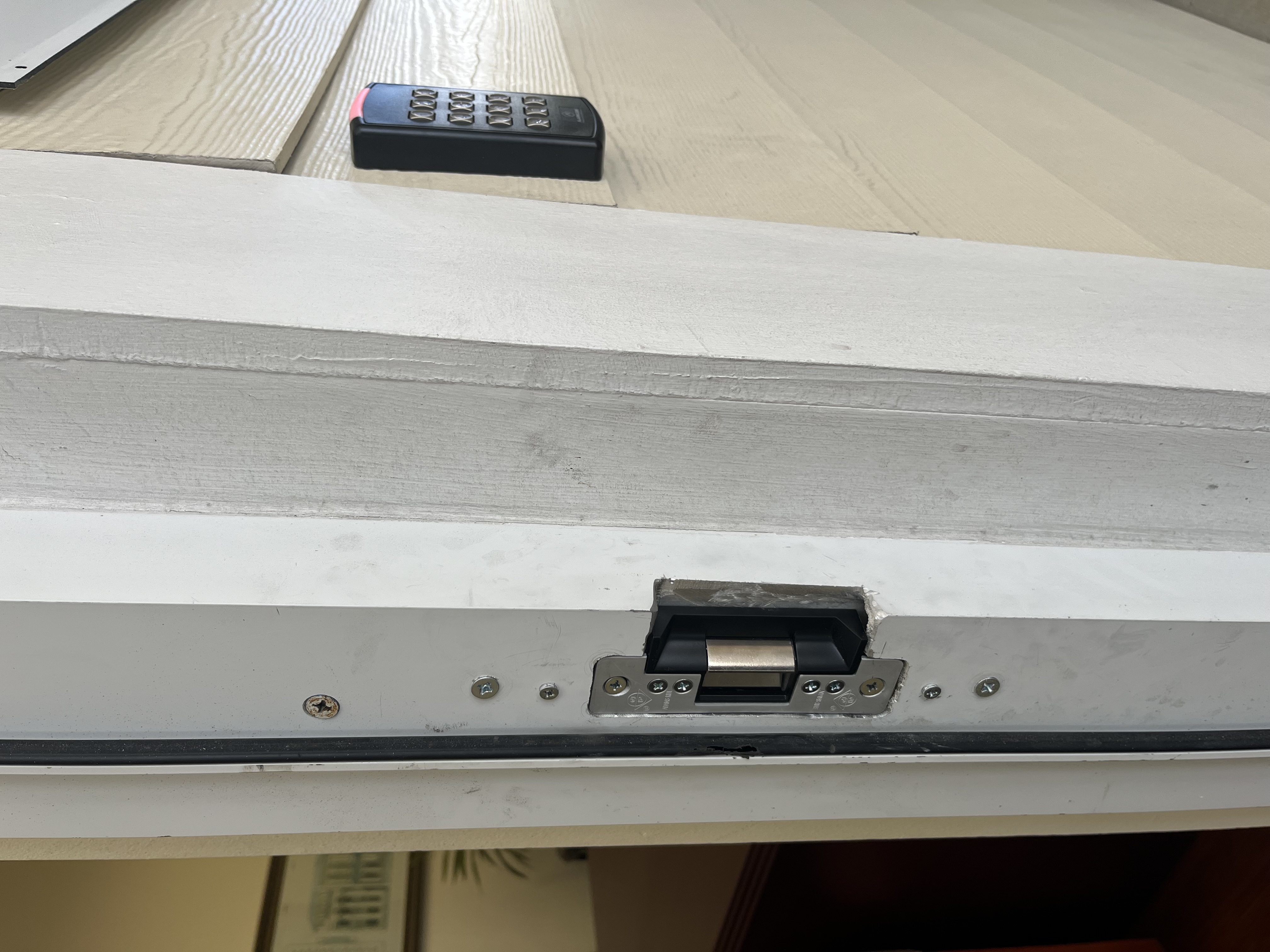 Commercial door frame: electric strike installed in frame, exterior keypad reader mounted on wall