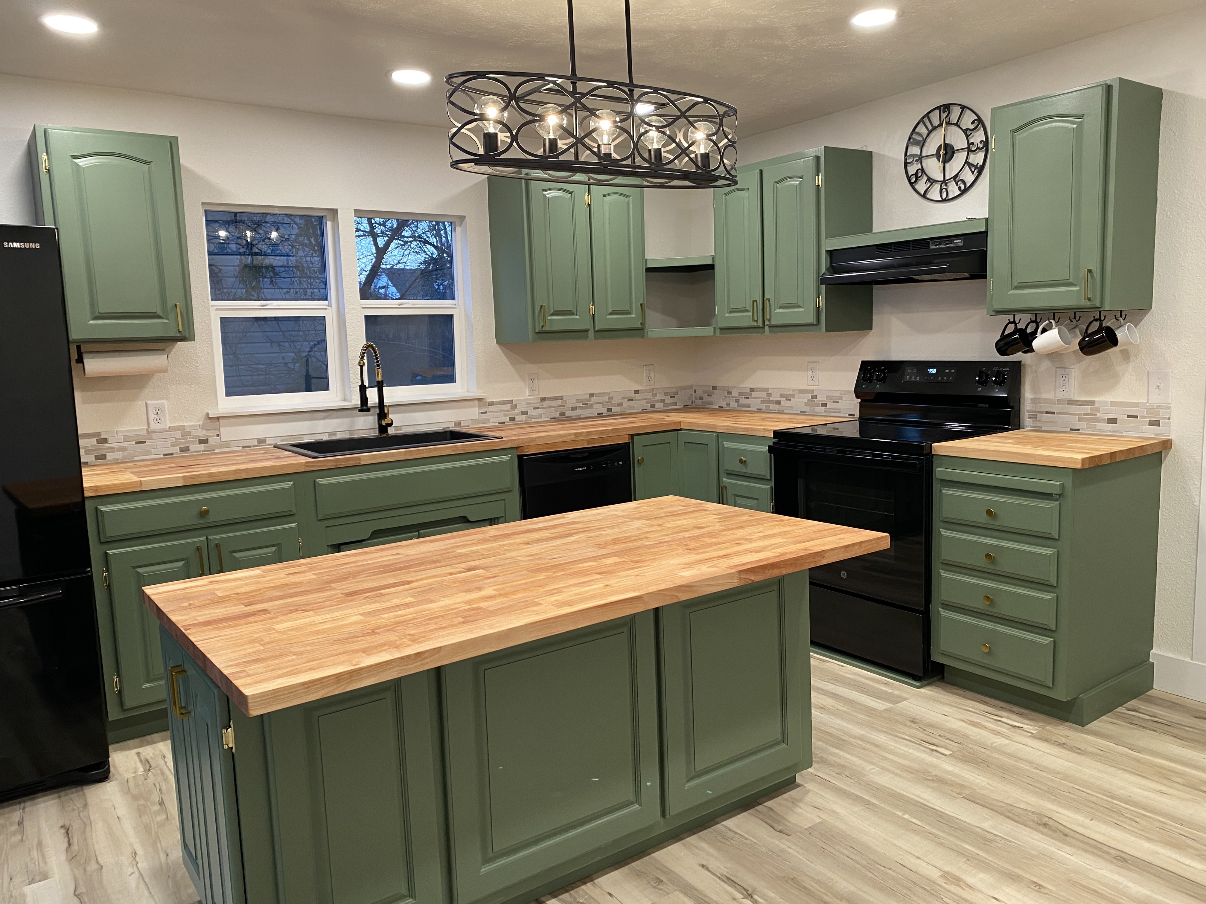 Renovated kitchen with sage green cabinets
