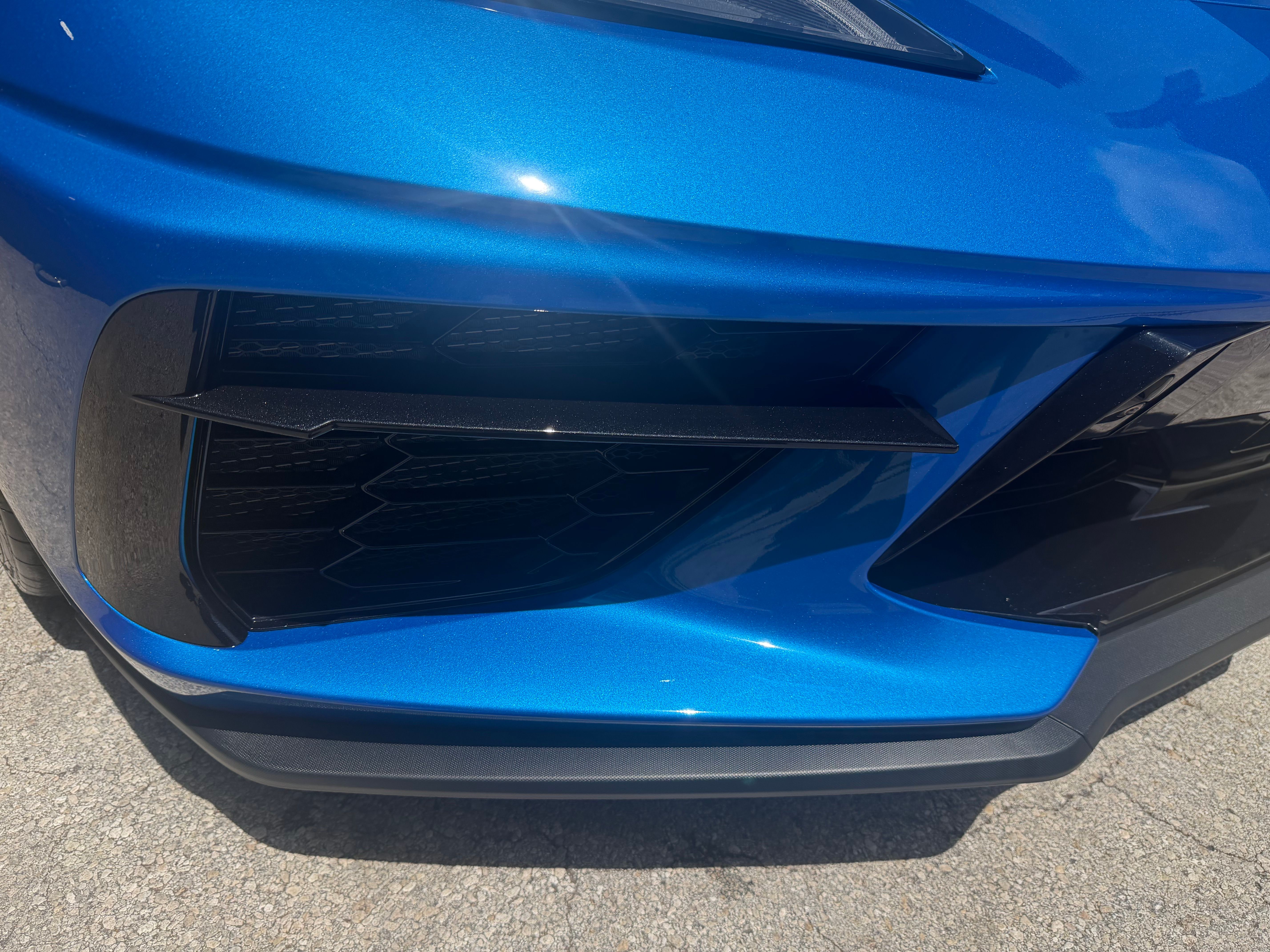 Close-up detail of Corvette C8 front bumper showing precision bodywork