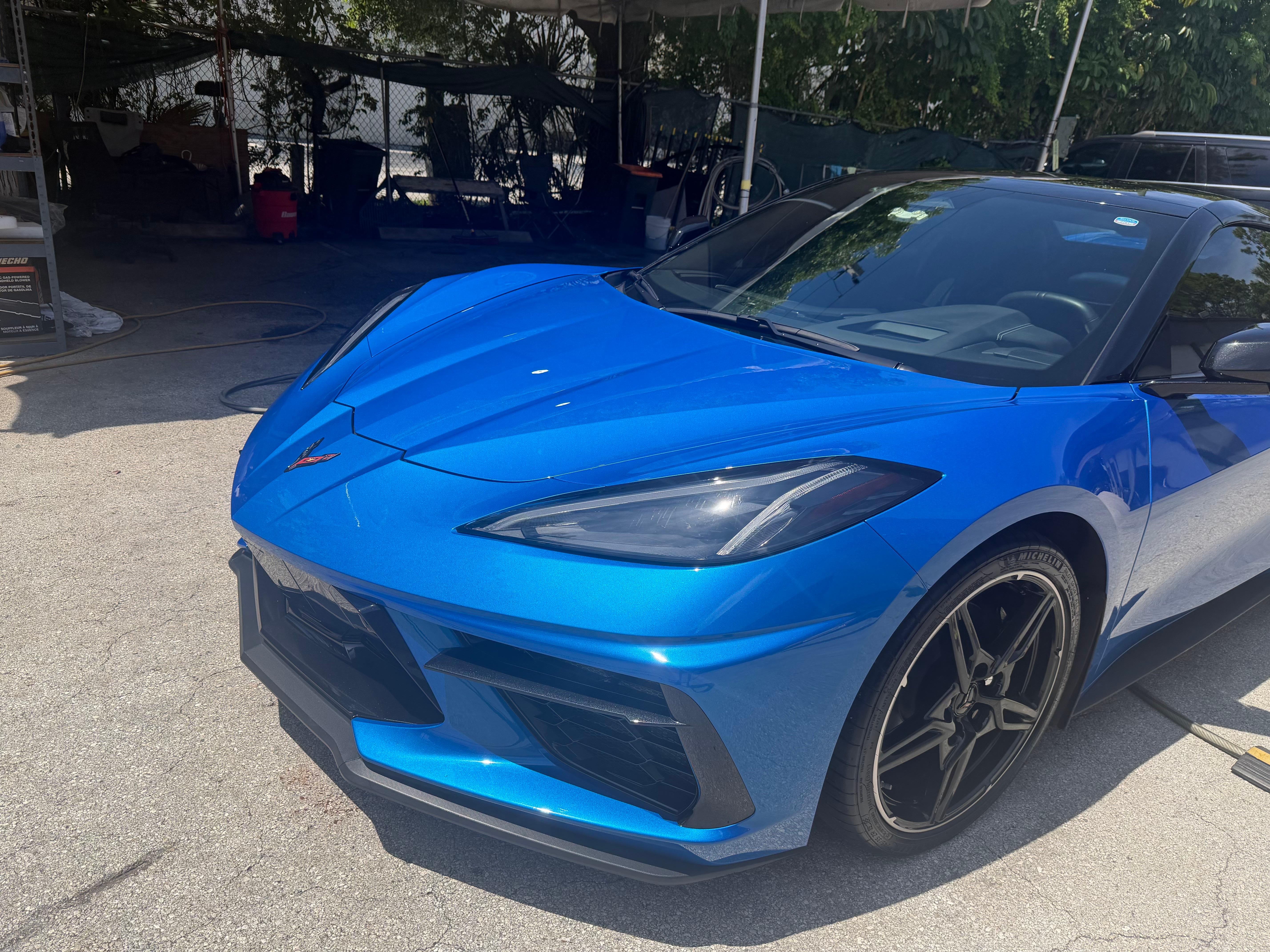 Rapid Blue Chevrolet Corvette C8 three-quarter angle showing flawless paint finish