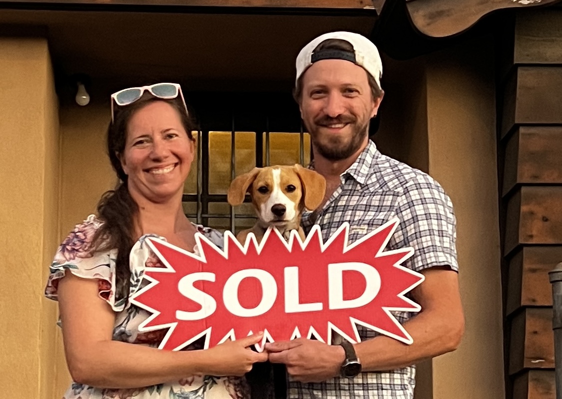 Dustin Cody with his family and the sold sign