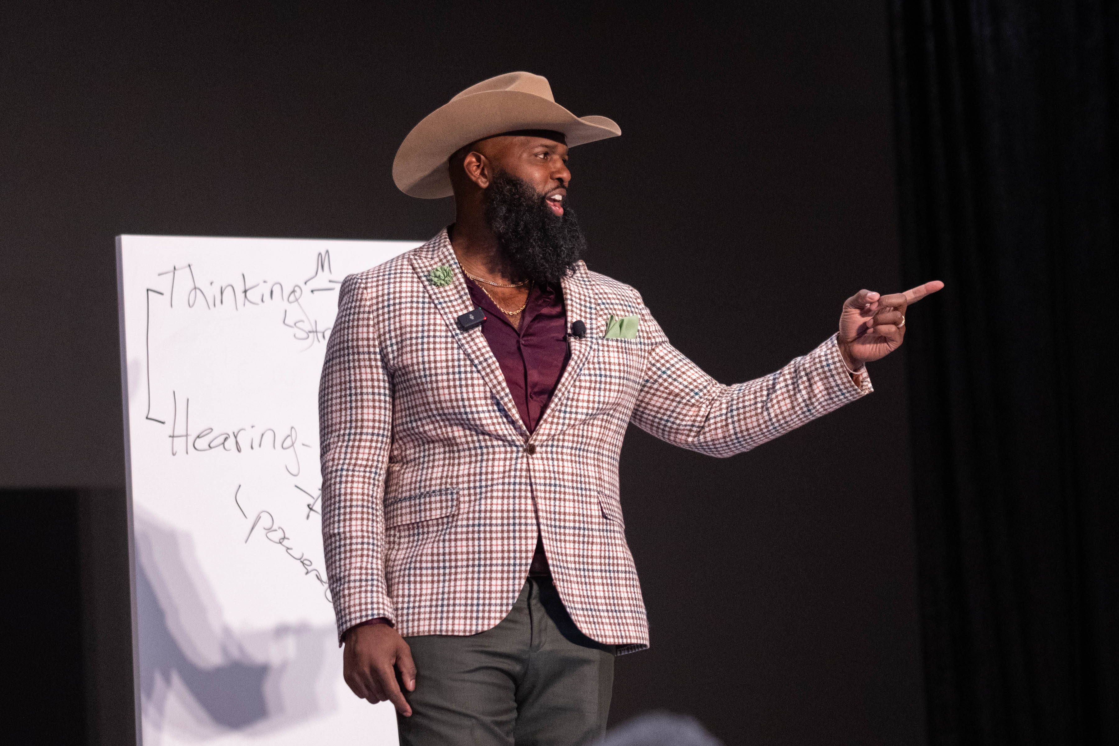 Andre Fluellen writing on a whiteboard during his keynote at MD Anderson's annual HR event