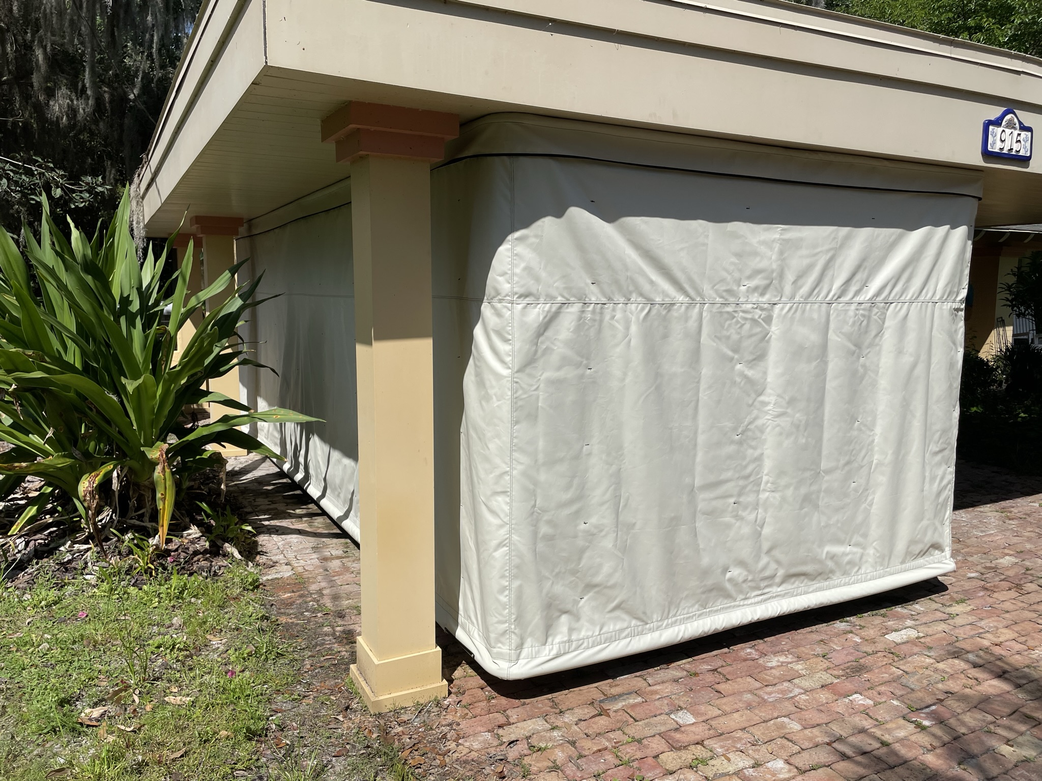 Touchless Cover fully closed under a carport protecting a vehicle