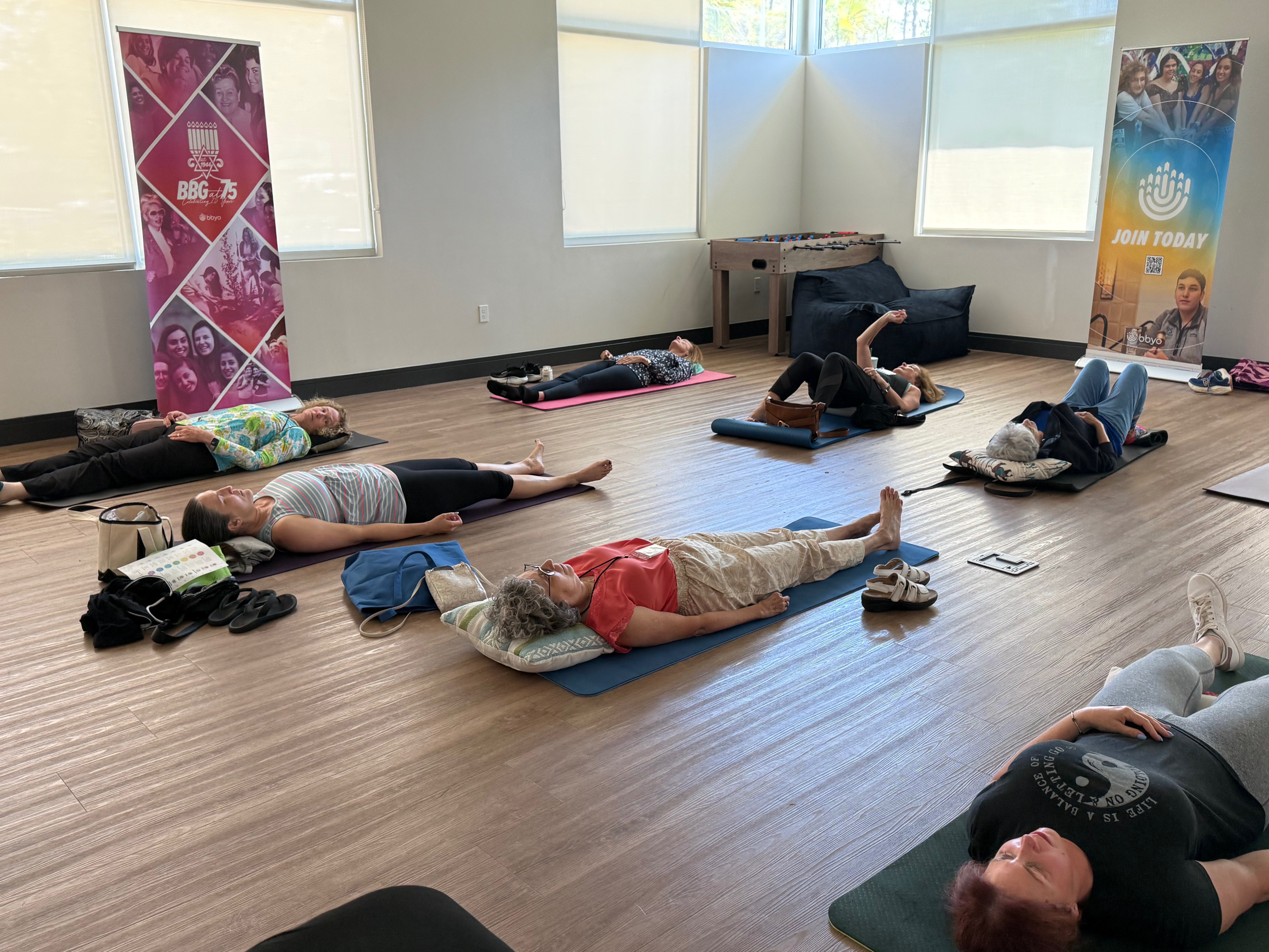 Class participants in relaxation pose during guided healing meditation
