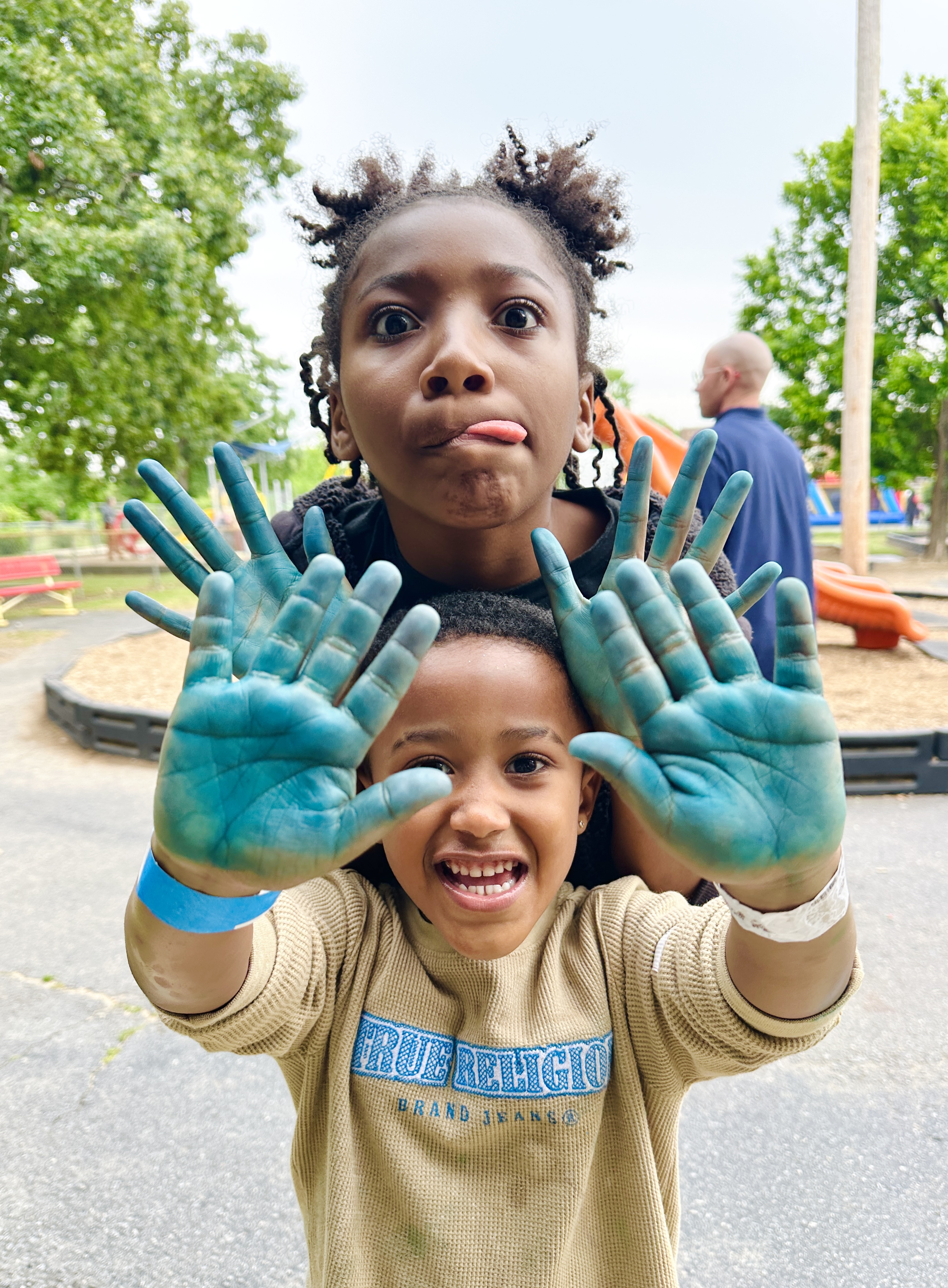 Kids showing off blue painted hands