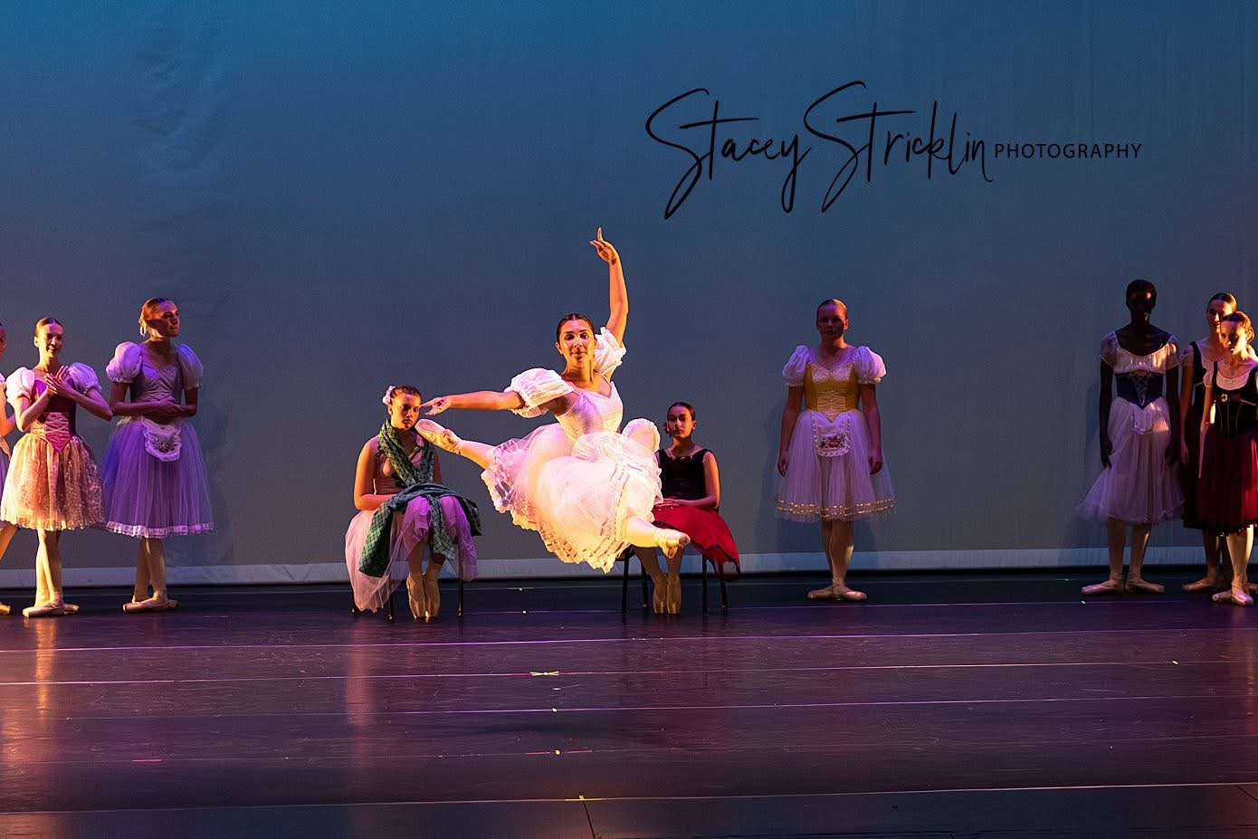 Ballet dancers performing a featured scene on stage