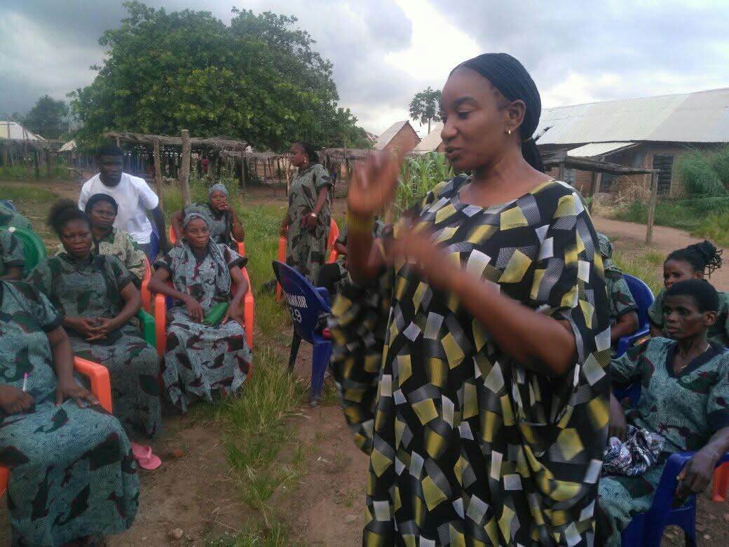 Mnena Ikondo Ikpa speaking with women outdoors