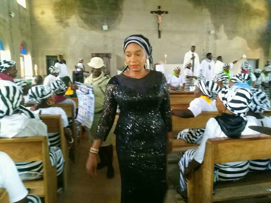 Mnena Ikondo Ikpa standing with a community in a church