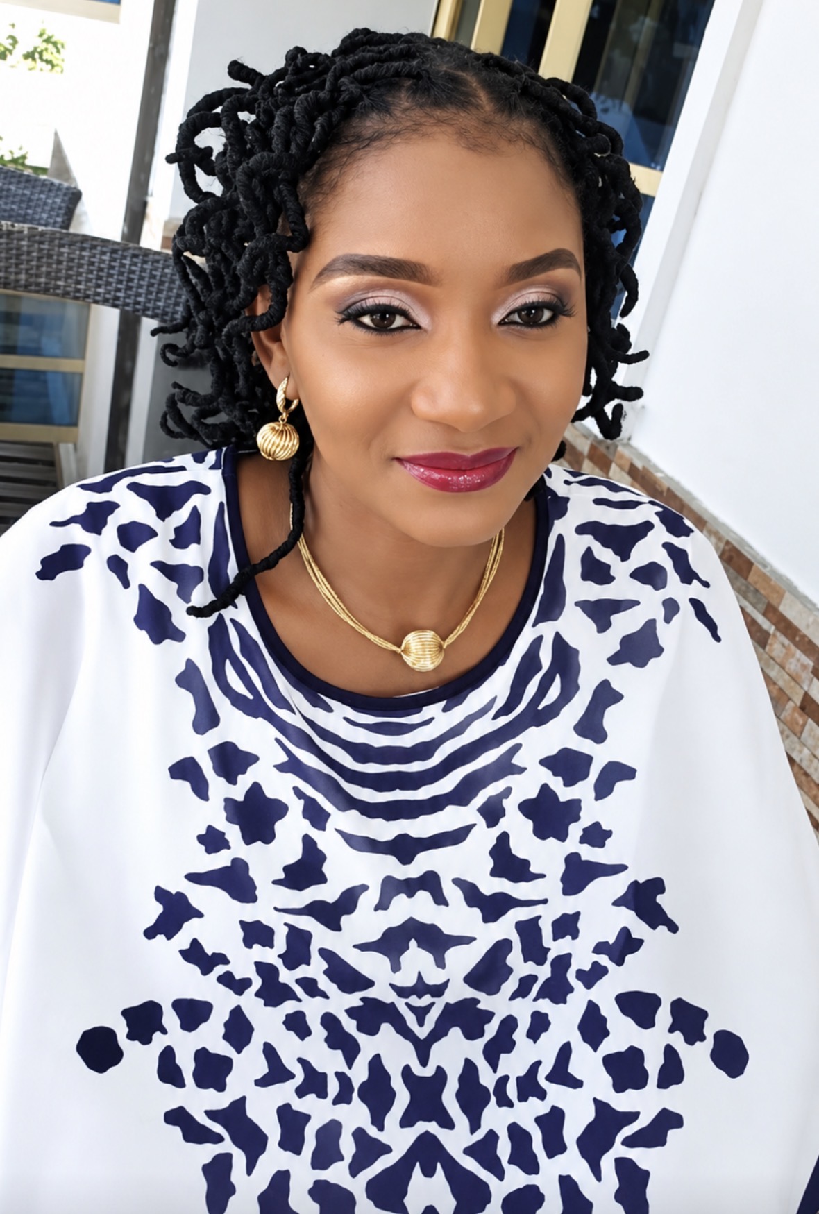 Mnena Ikondo Ikpa smiling in a traditional patterned outfit