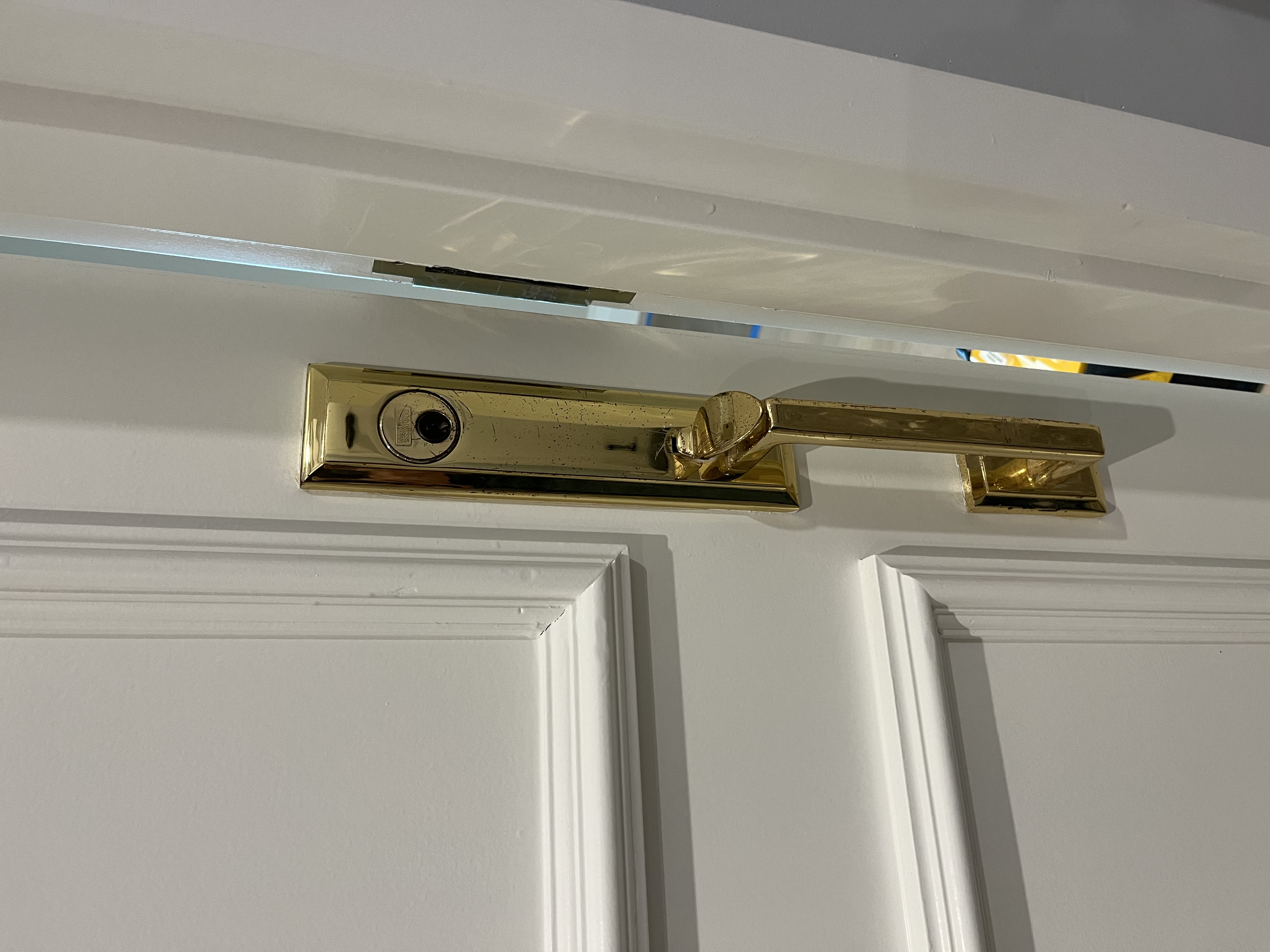 Before: aged brass Baldwin handleset showing wear and discoloration