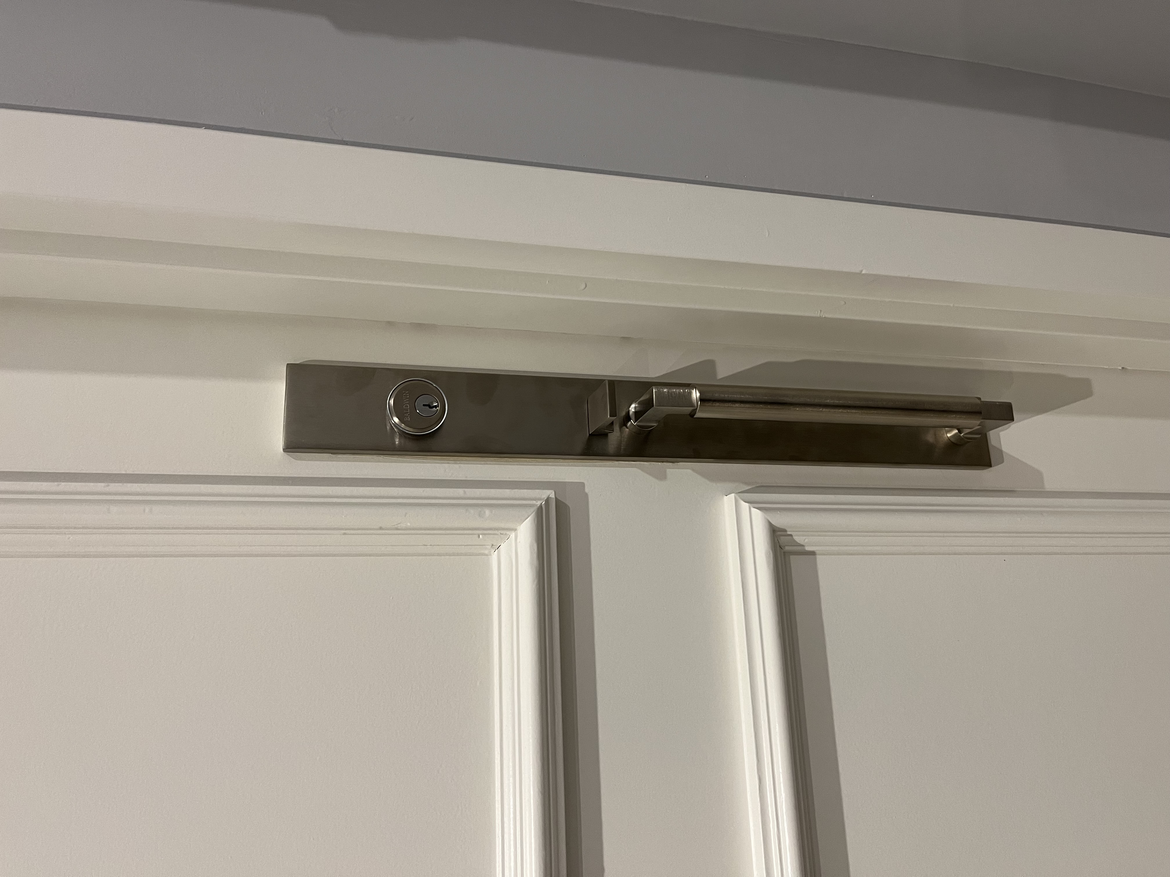 After: completed Baldwin Estate satin nickel lever and mortise lock on white door interior