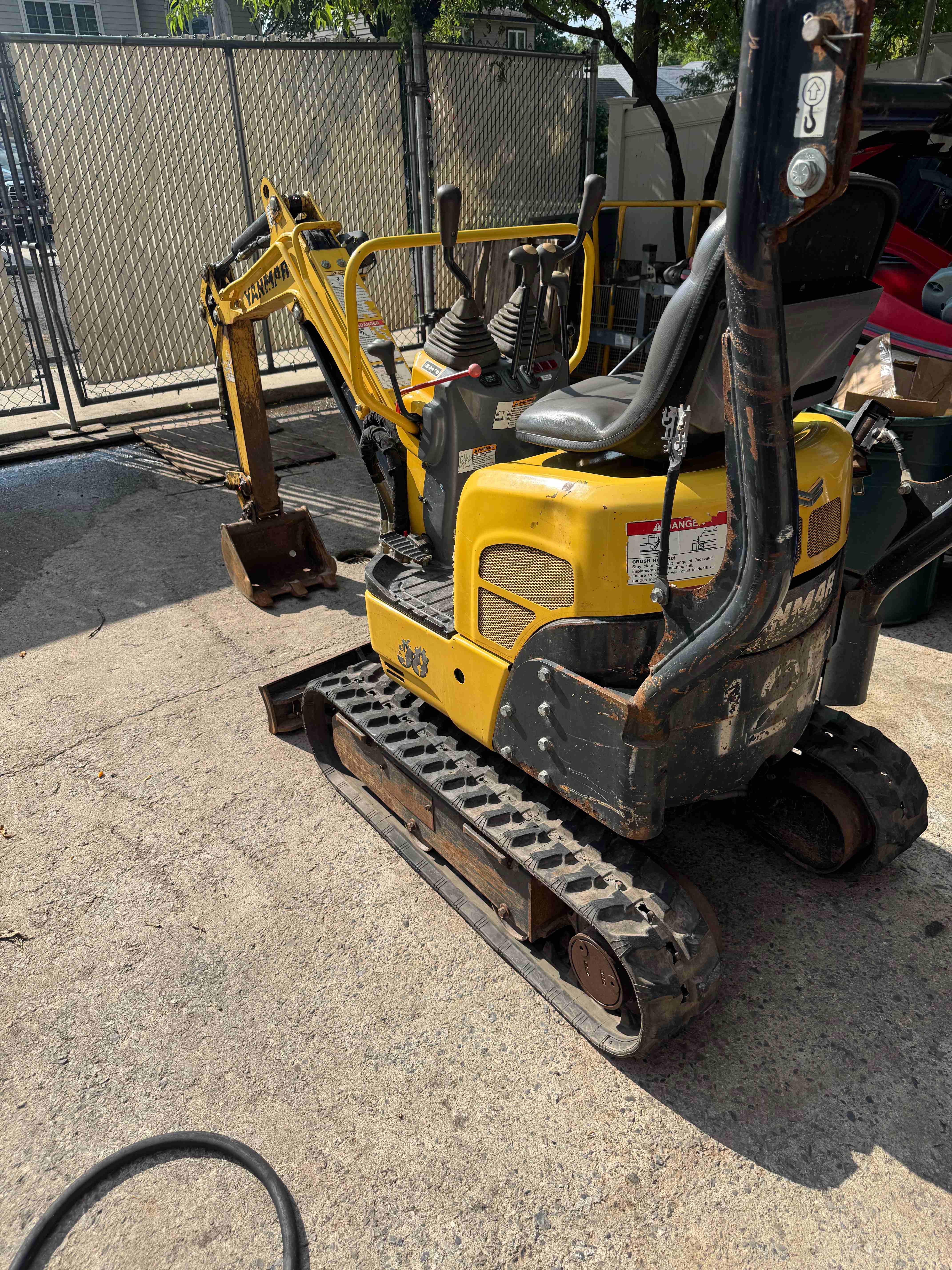 Yanmar SV08 mini excavator operator seat and control joysticks close up
