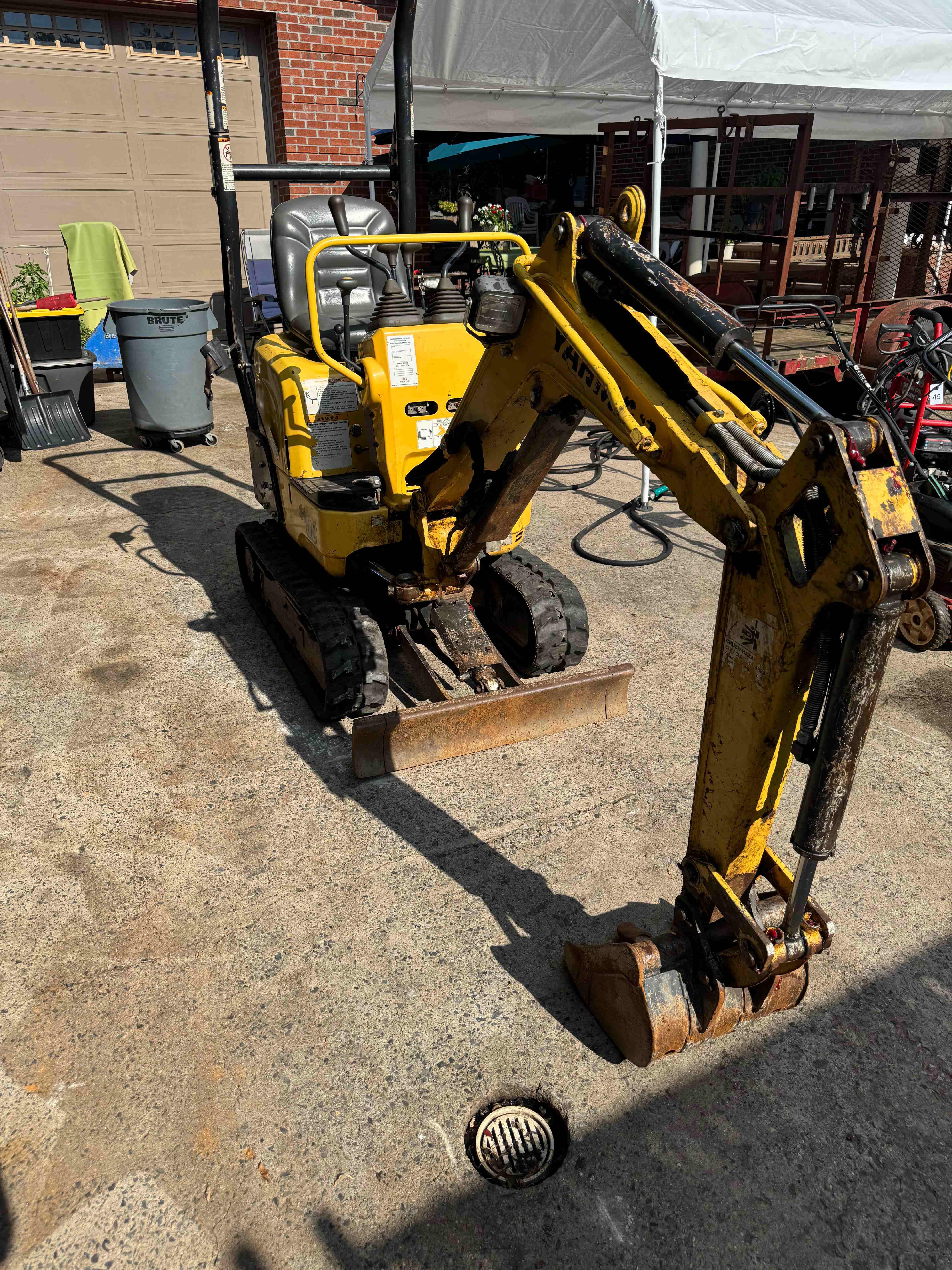 Yanmar SV08 mini excavator front three-quarter view showing the blade and boom