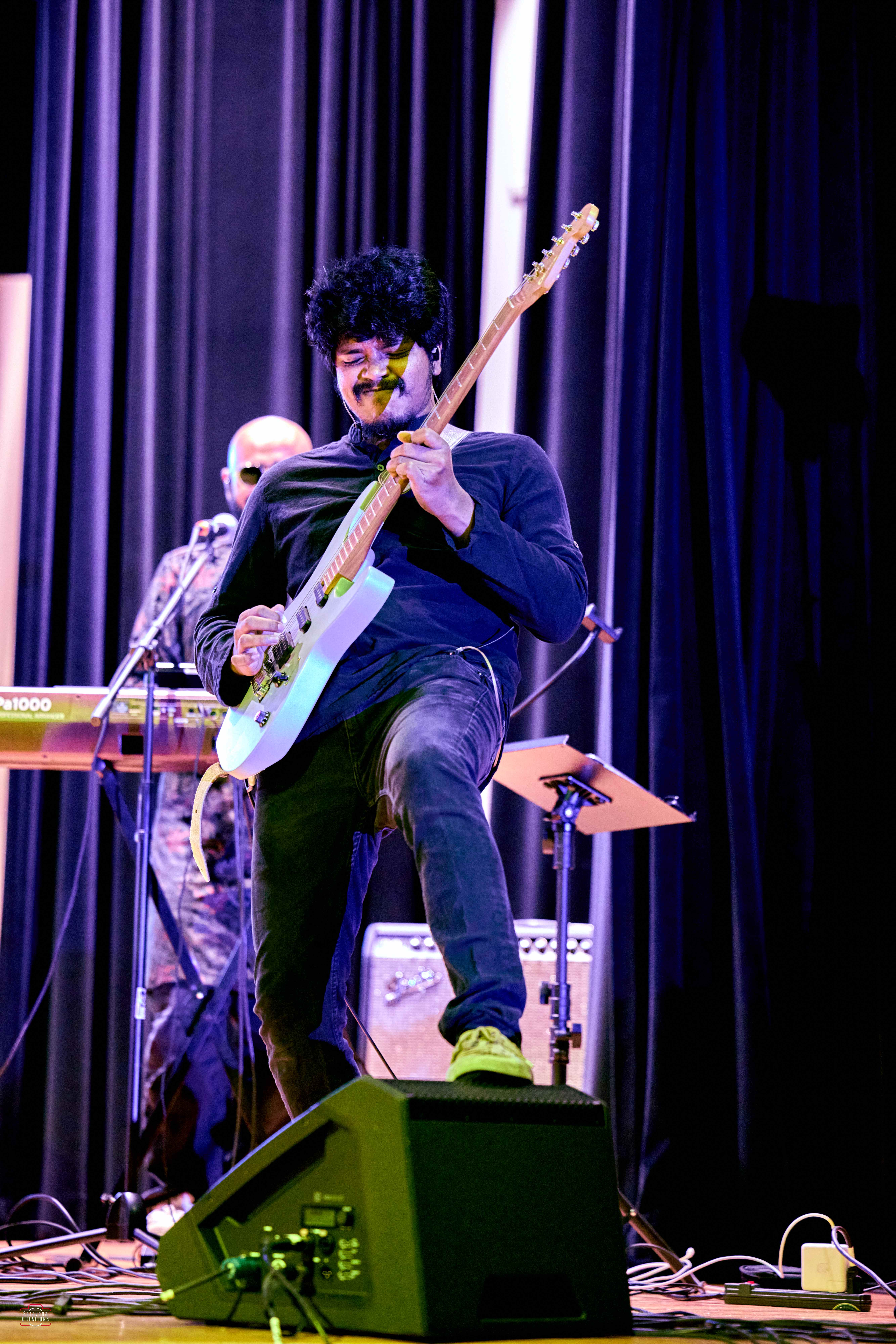 Guitarist performing energetically on stage