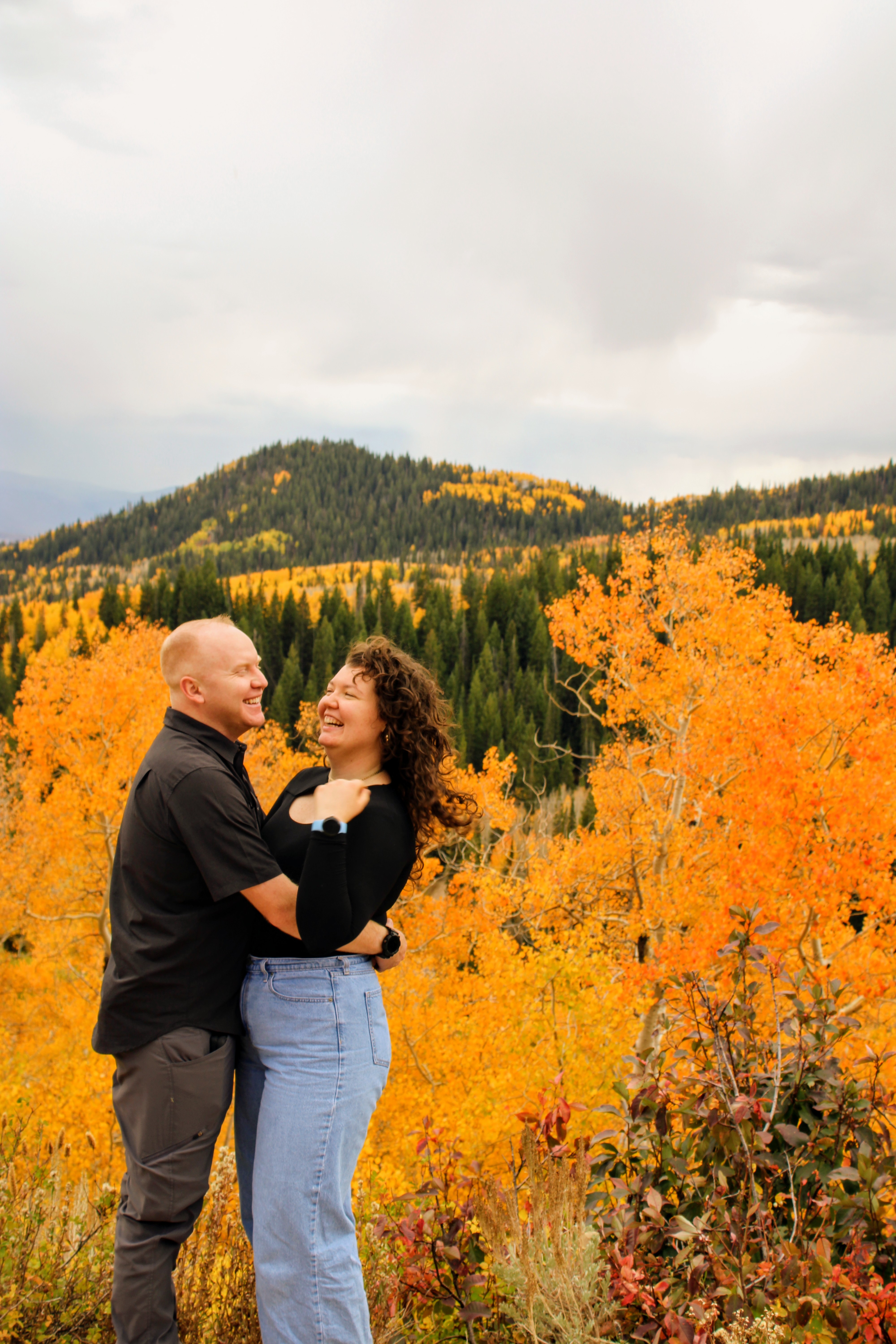 Sydney & Bryan laughing in fall colors