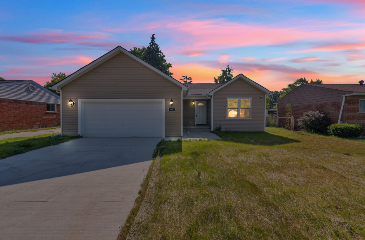 A completed Emerald Stone Construction home at sunset