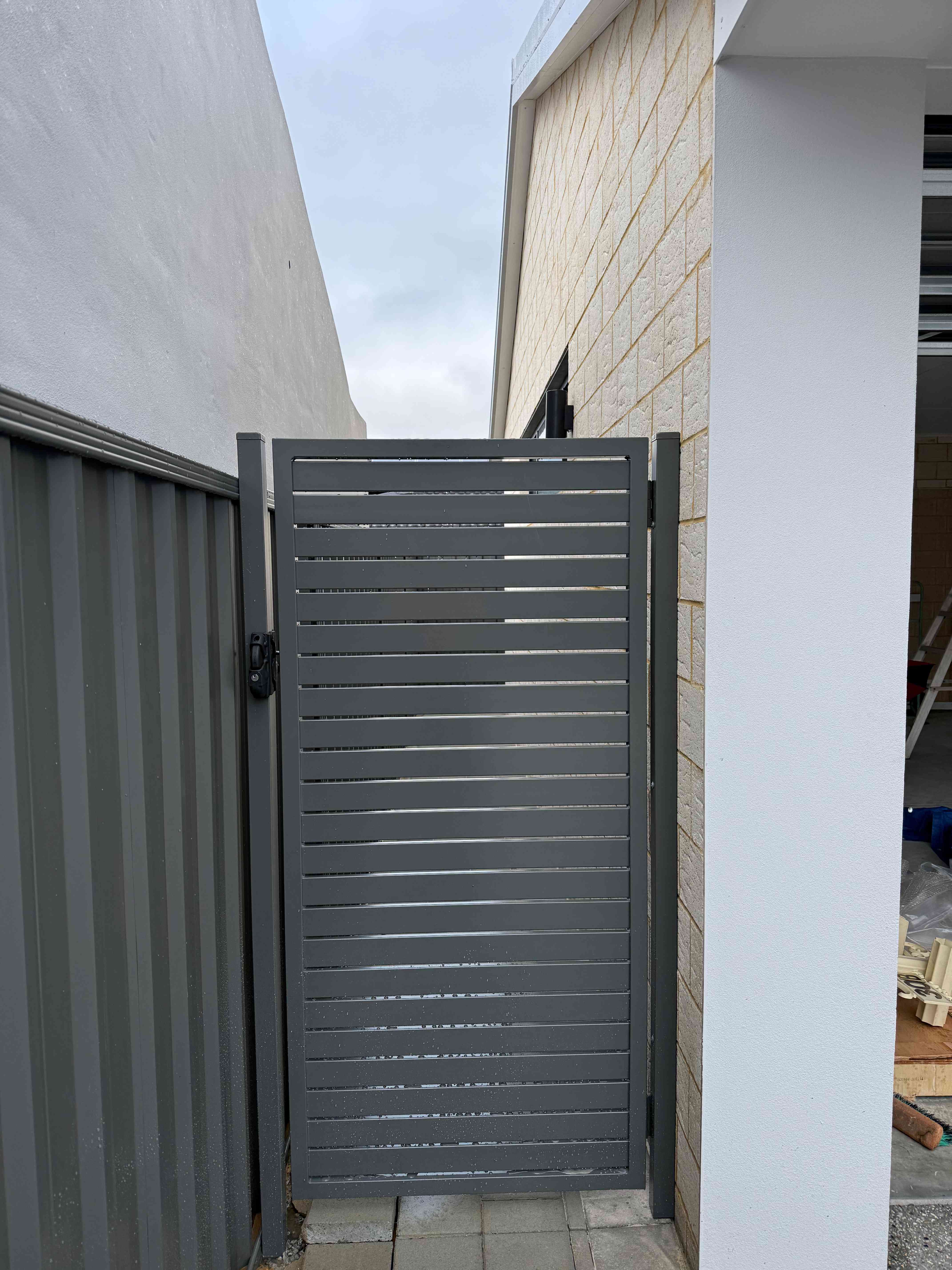 Modern grey aluminium slat gate installation