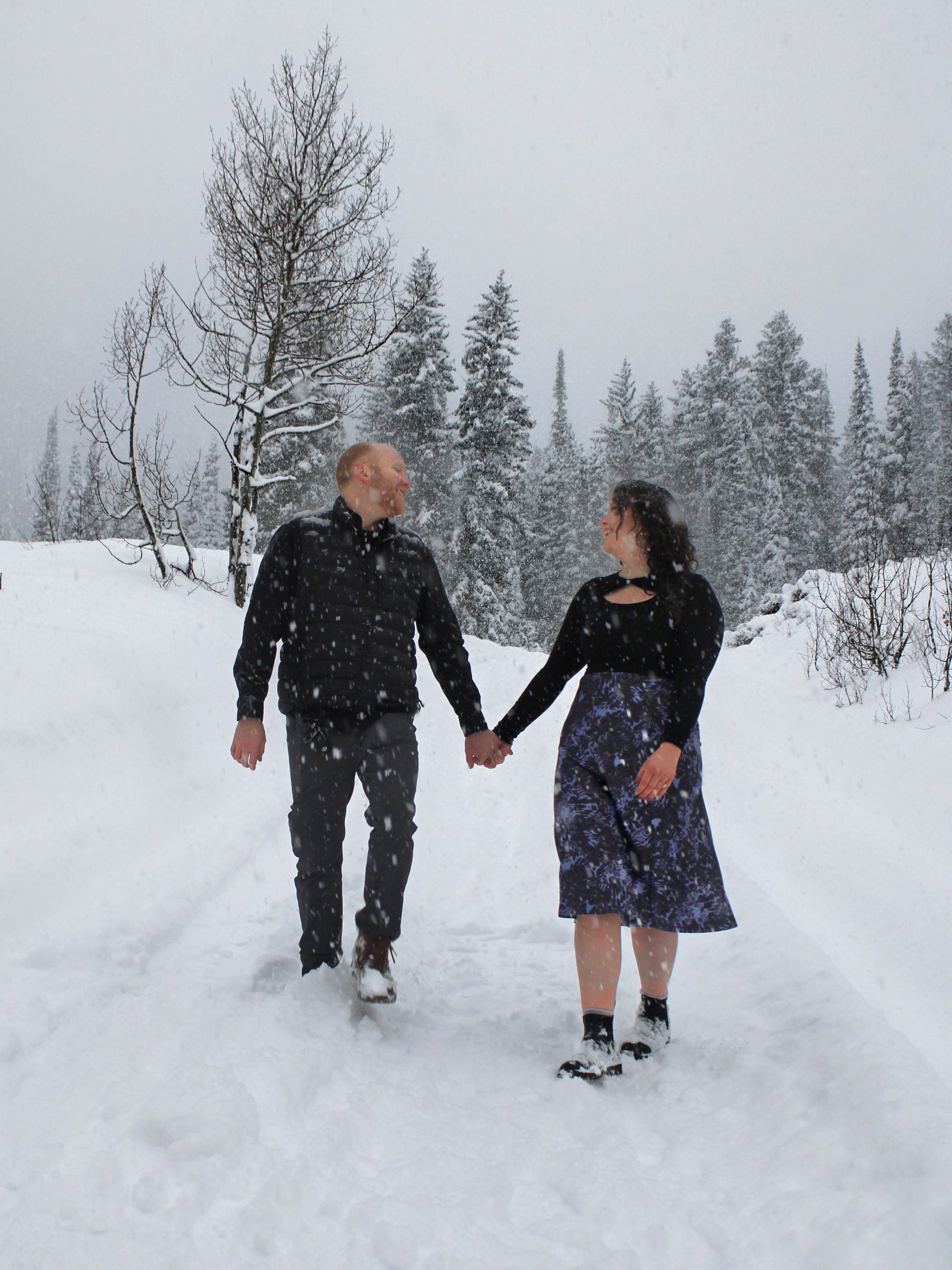 Sydney & Bryan holding hands in snow