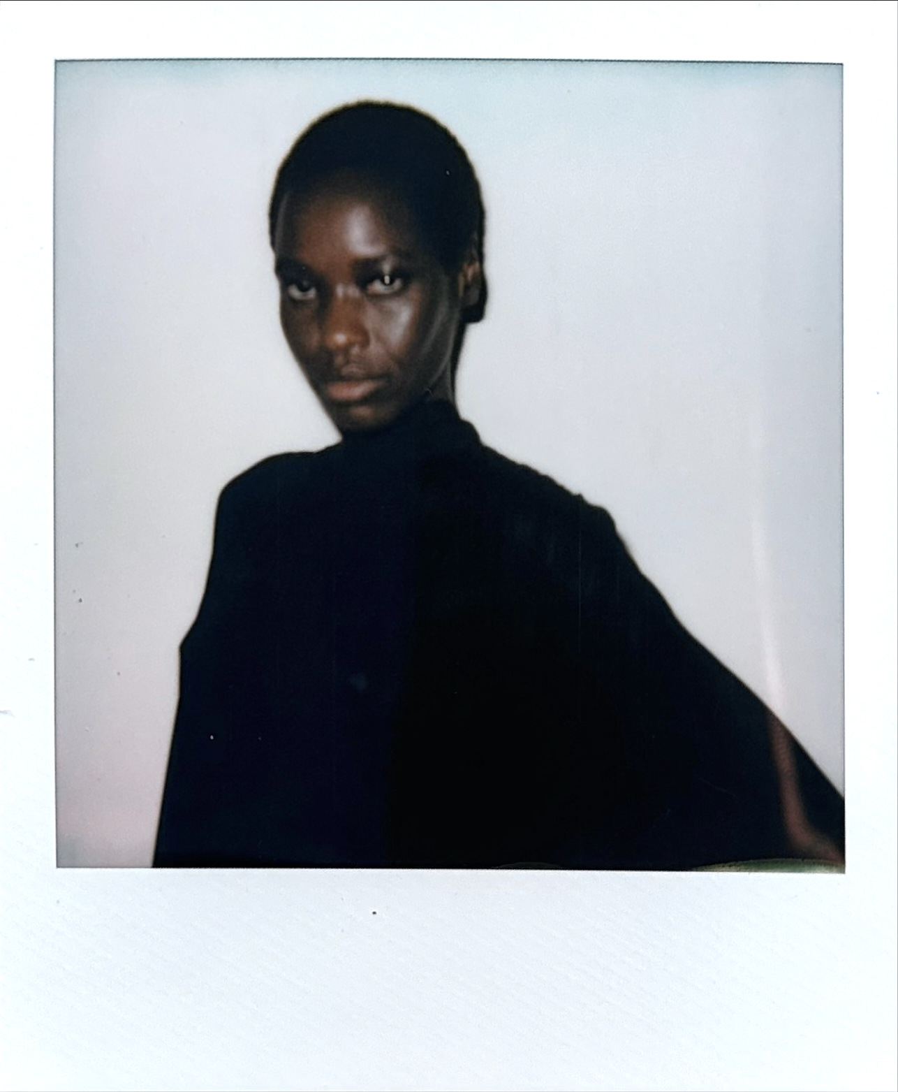 Polaroid portrait woman with shaved head in black turtleneck
