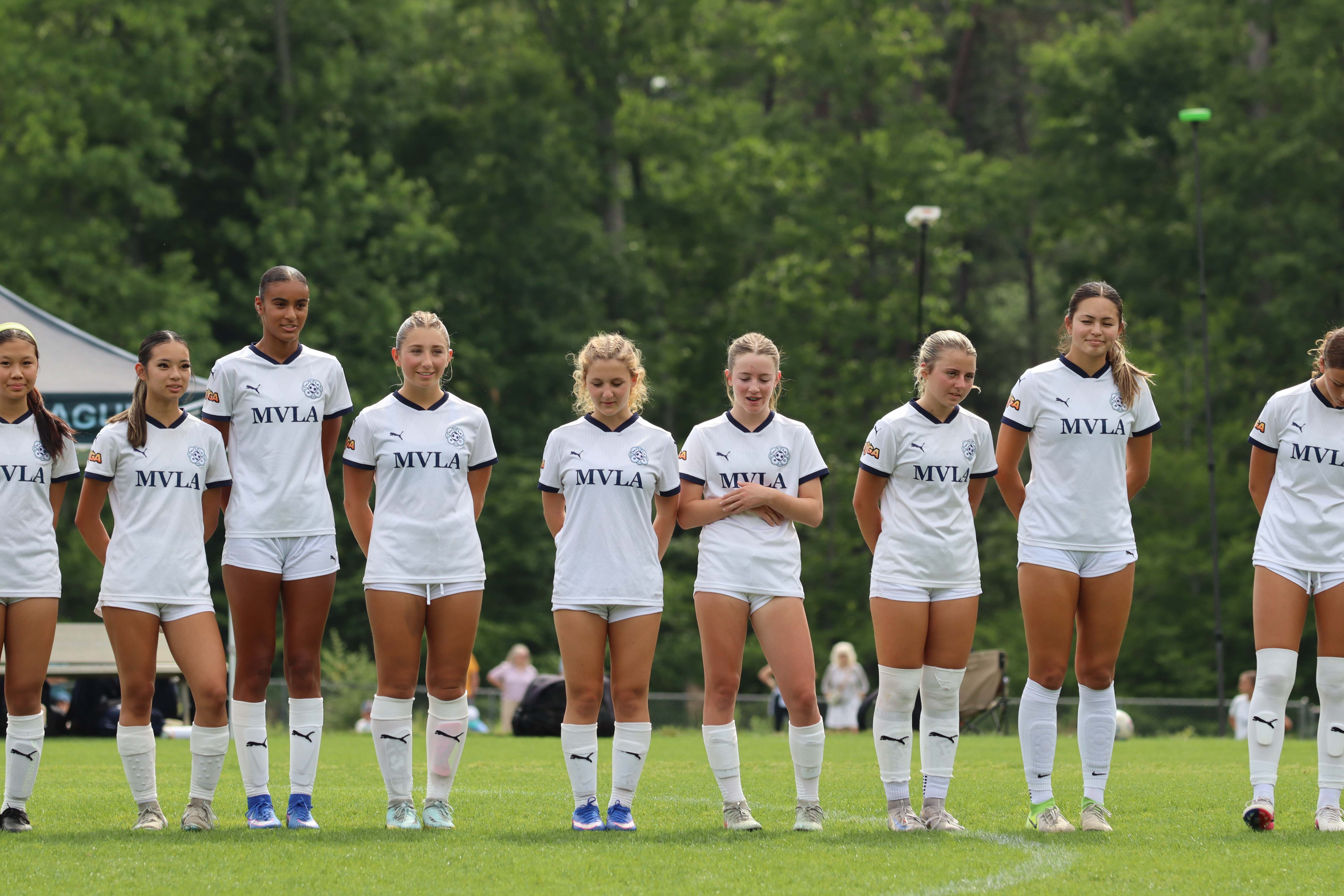Team lined up in white kits