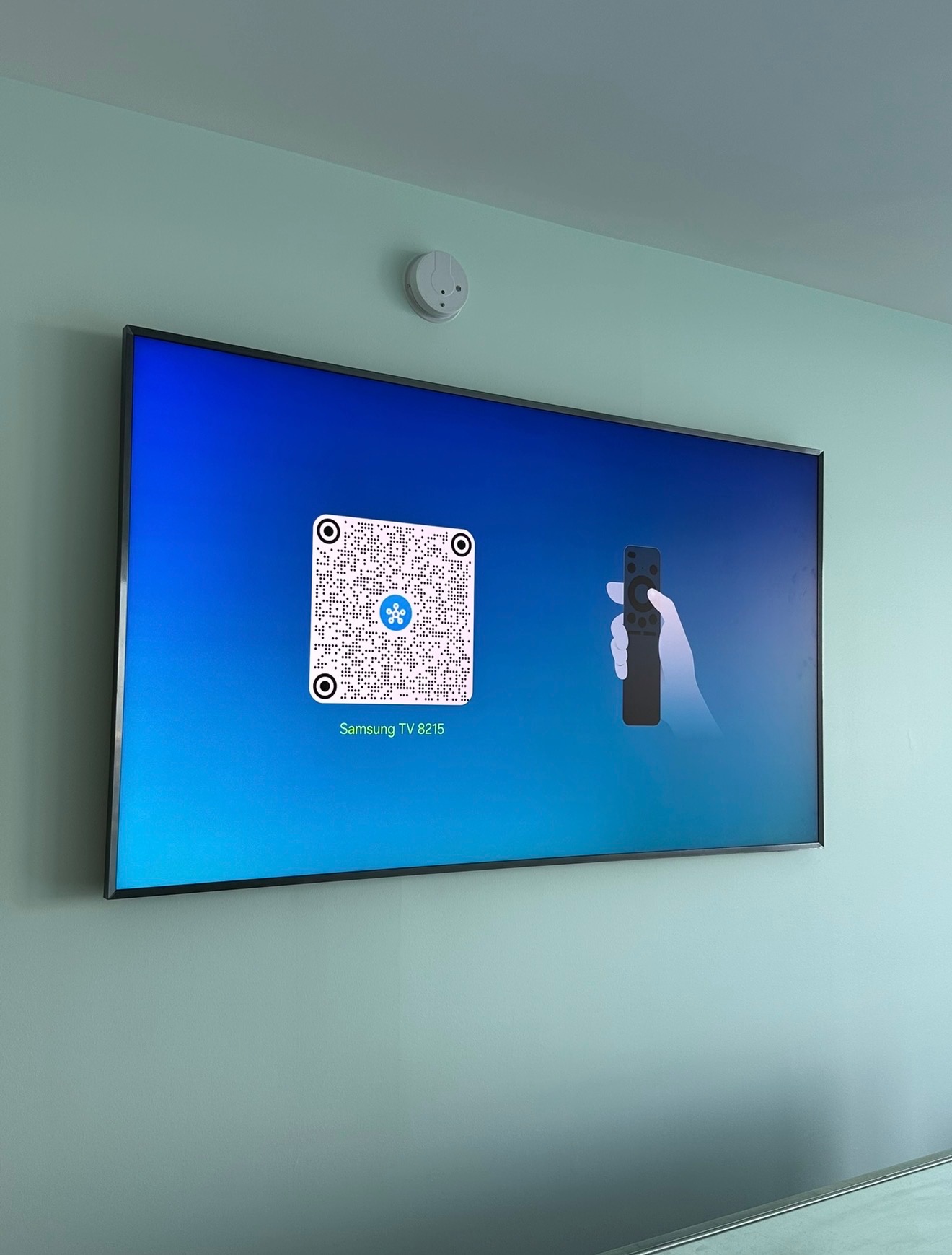 Samsung TV mounted on mint green wall