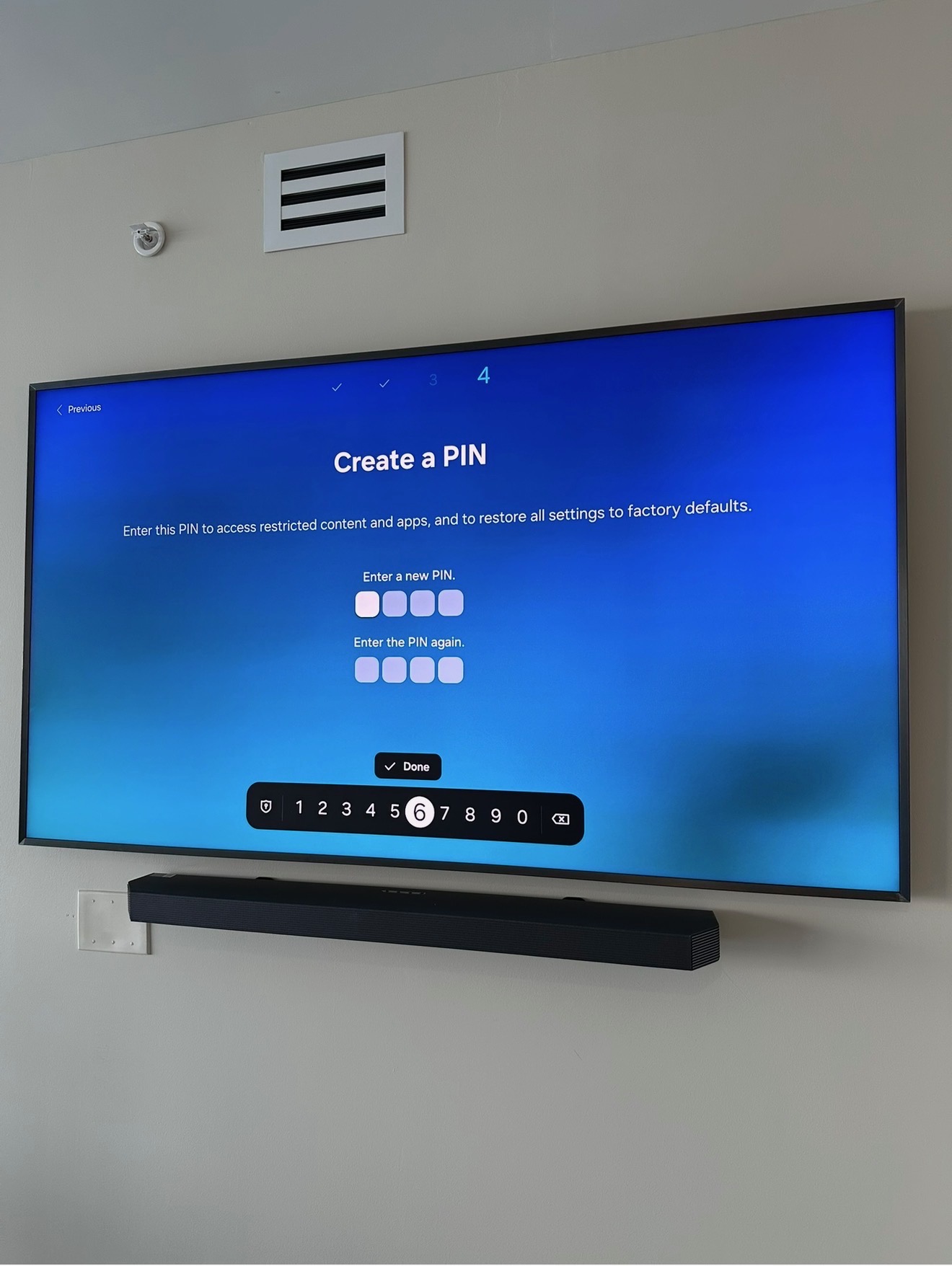TV with soundbar mounted on gray wall
