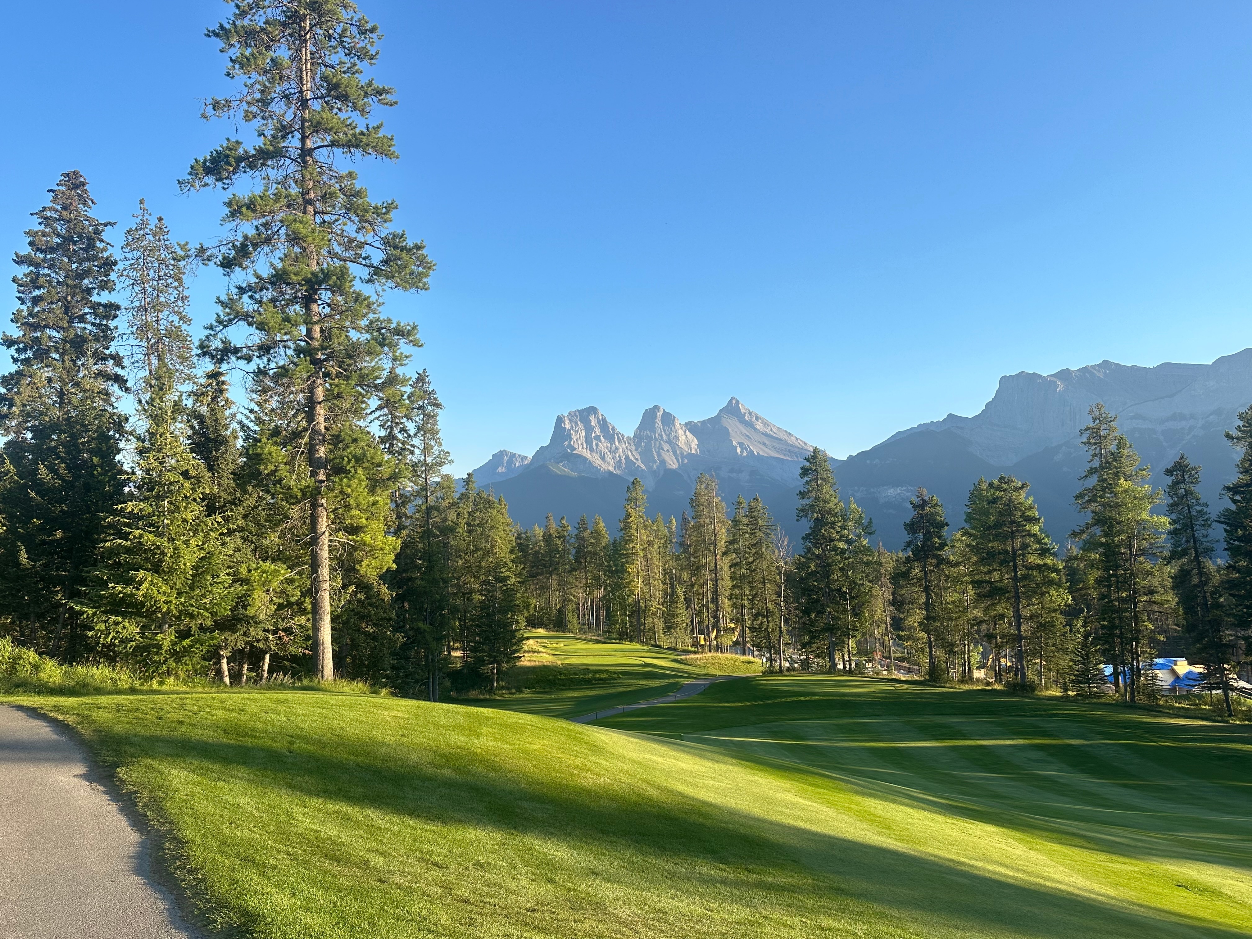 The Three Sisters mountain peaks viewed from a Canmore golf course