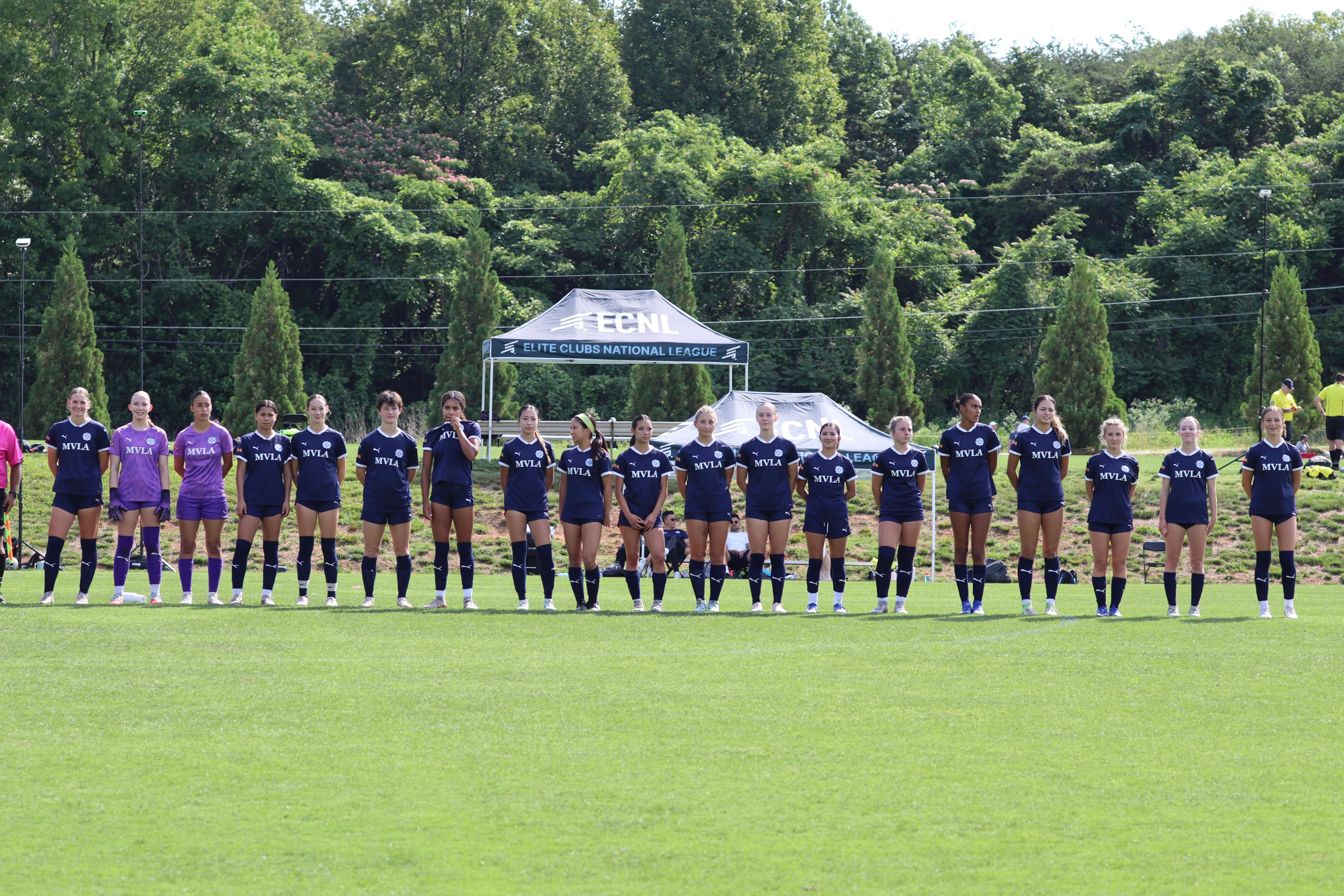 Team lined up in navy kits