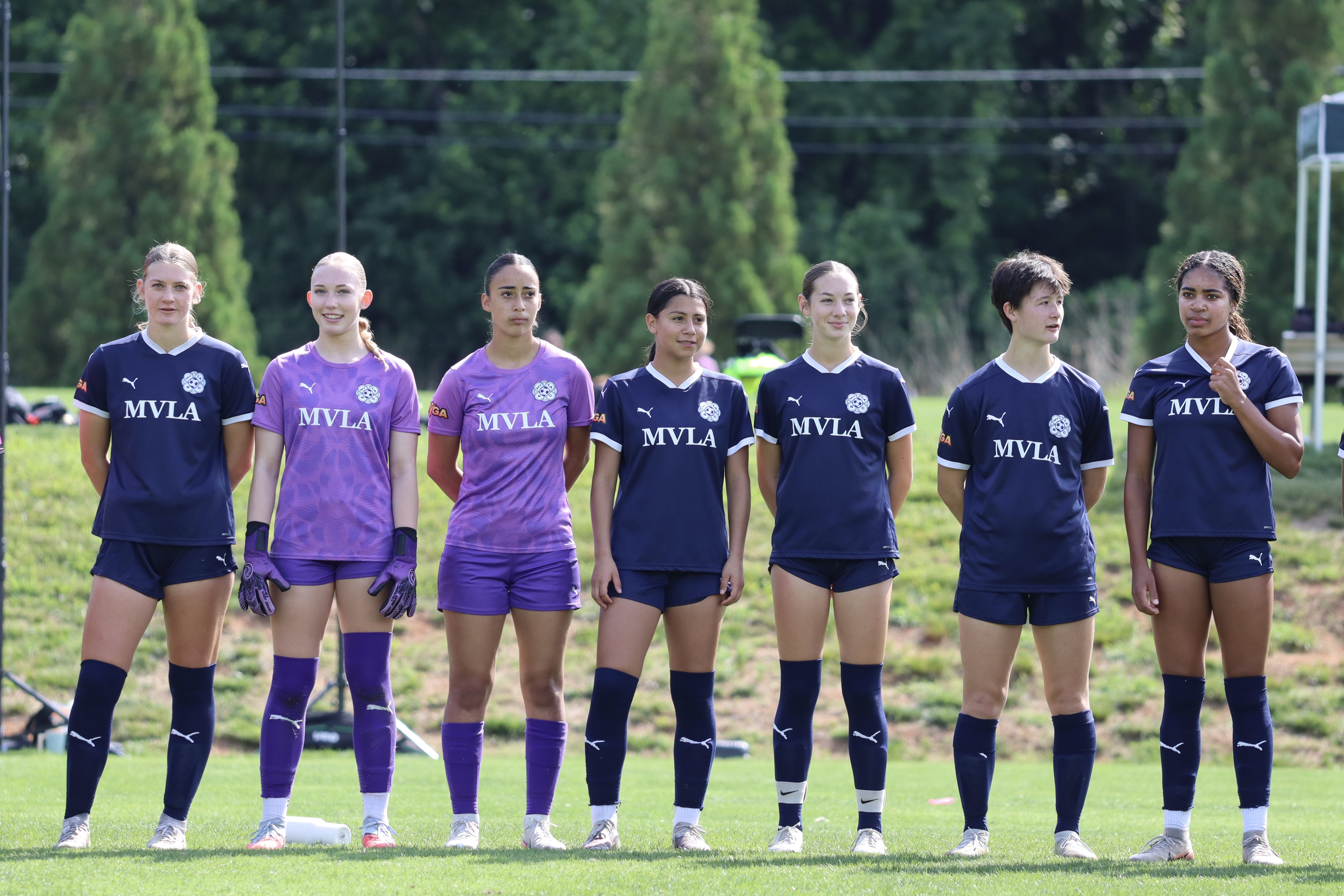 Players lined up in navy and purple