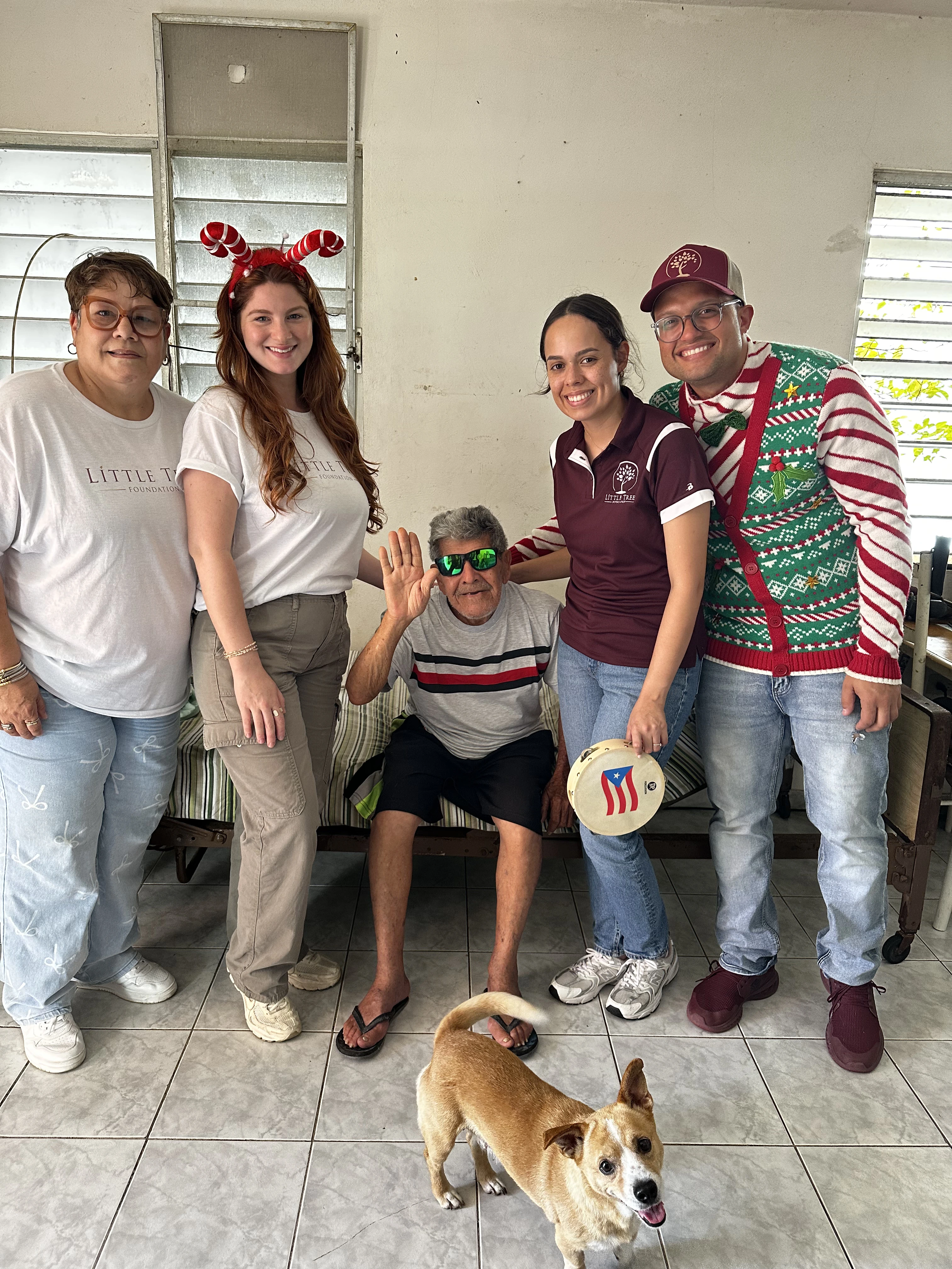 Grupo de voluntarios celebrando con adulto mayor