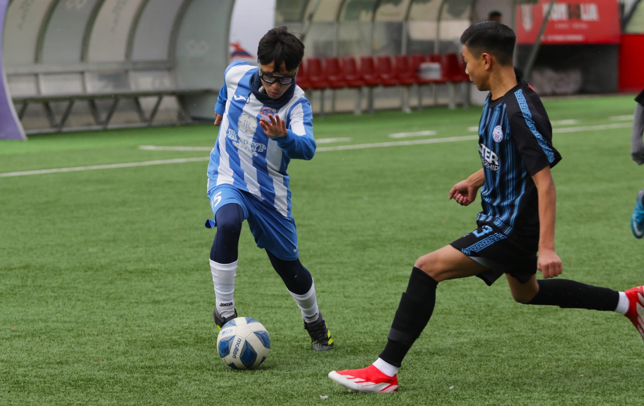 Erkhembold dribbling against defender