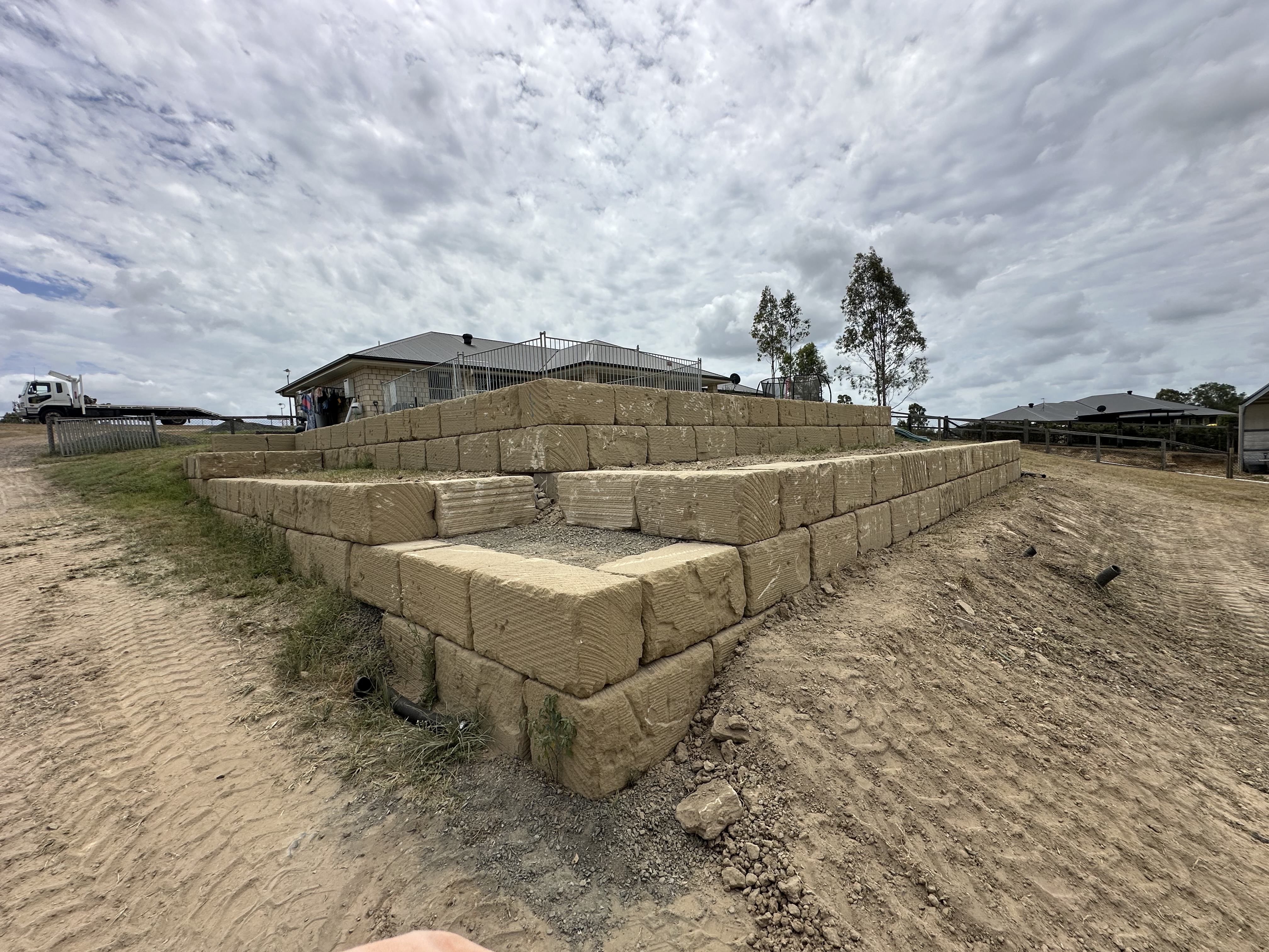 Tiered sandstone block retaining wall showing corner detail