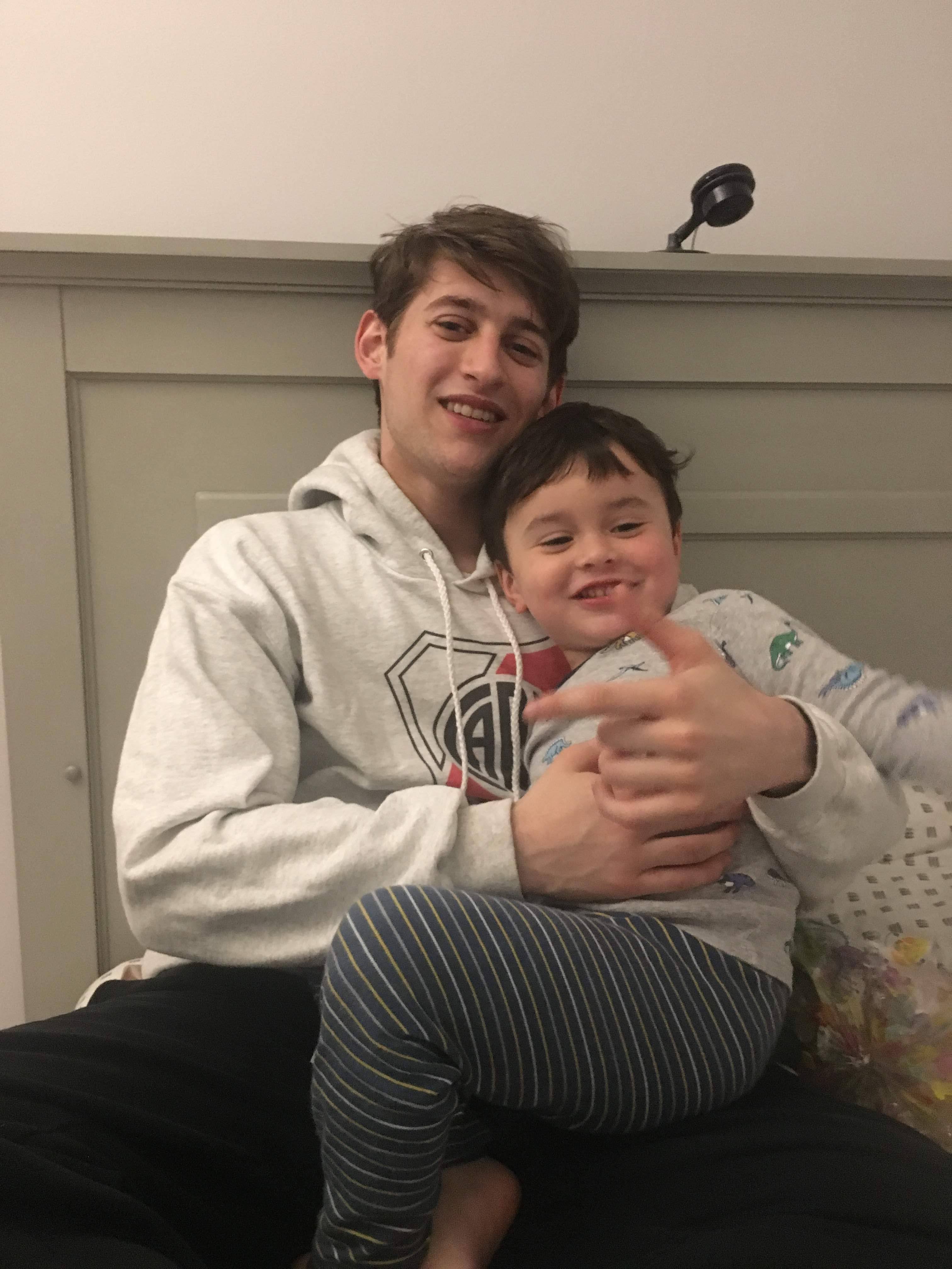 Alex with young child showing his caring nature