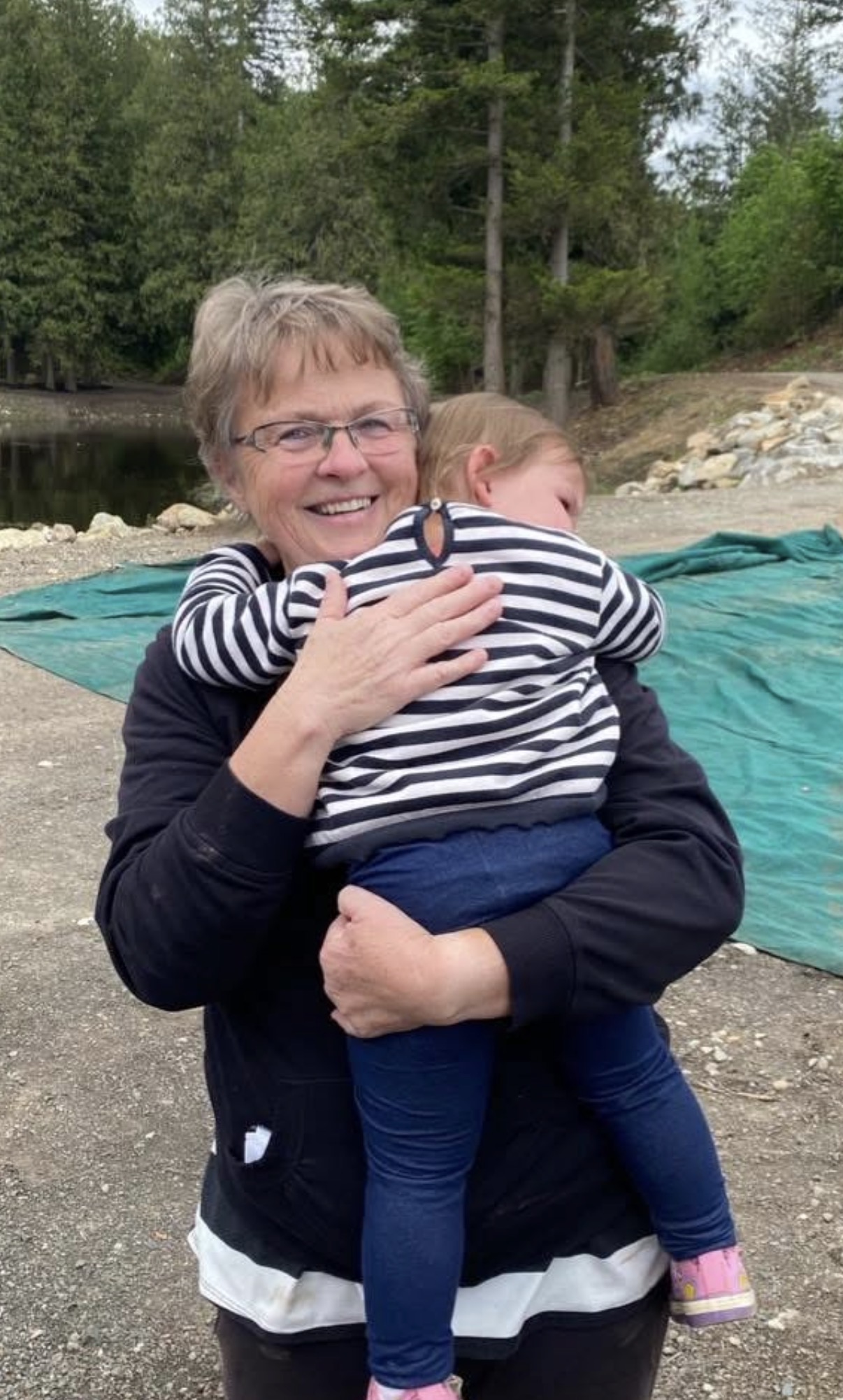 Mom holding her grandchild, smiling