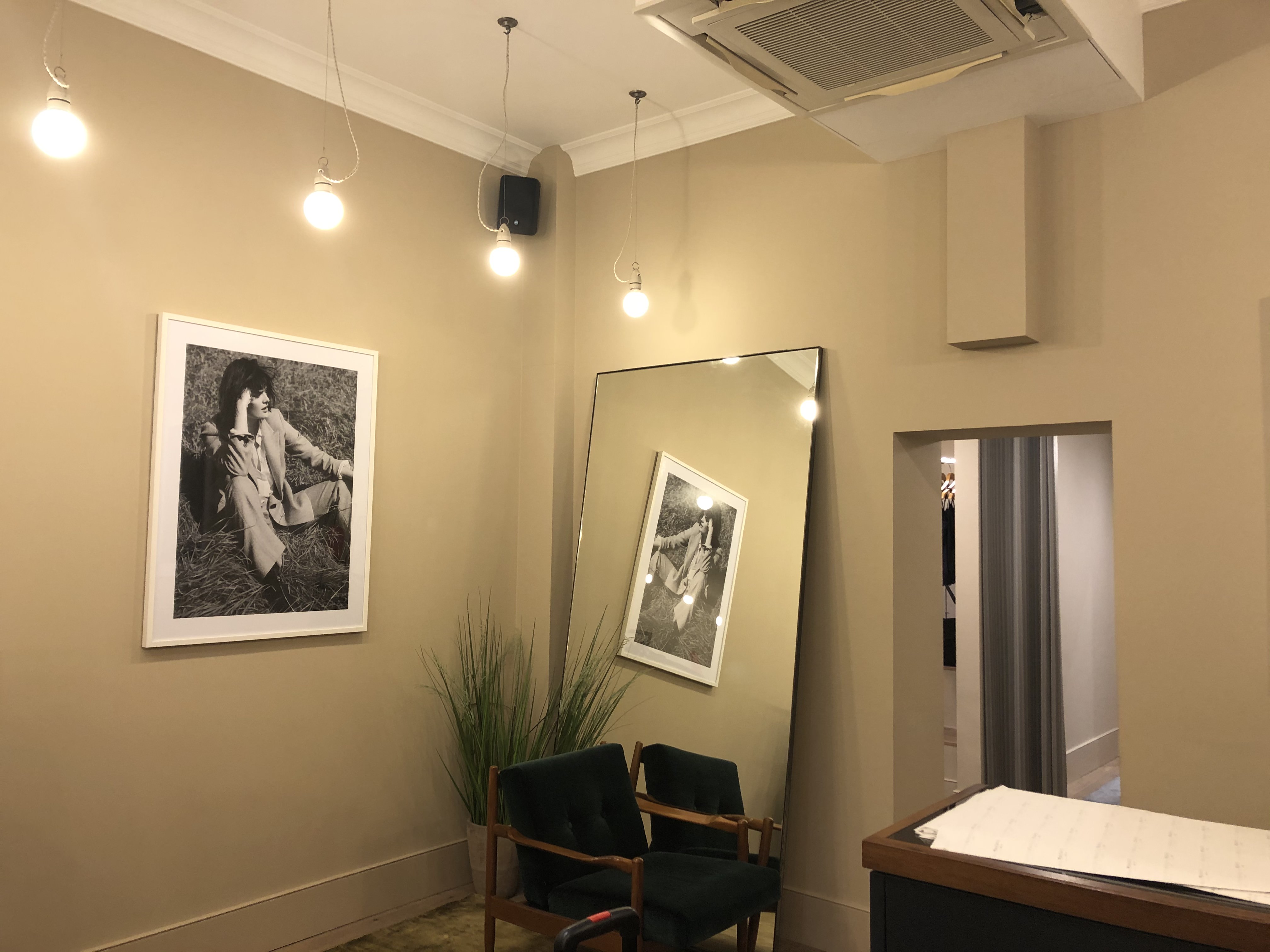 Interior seating area with fashion photography artwork