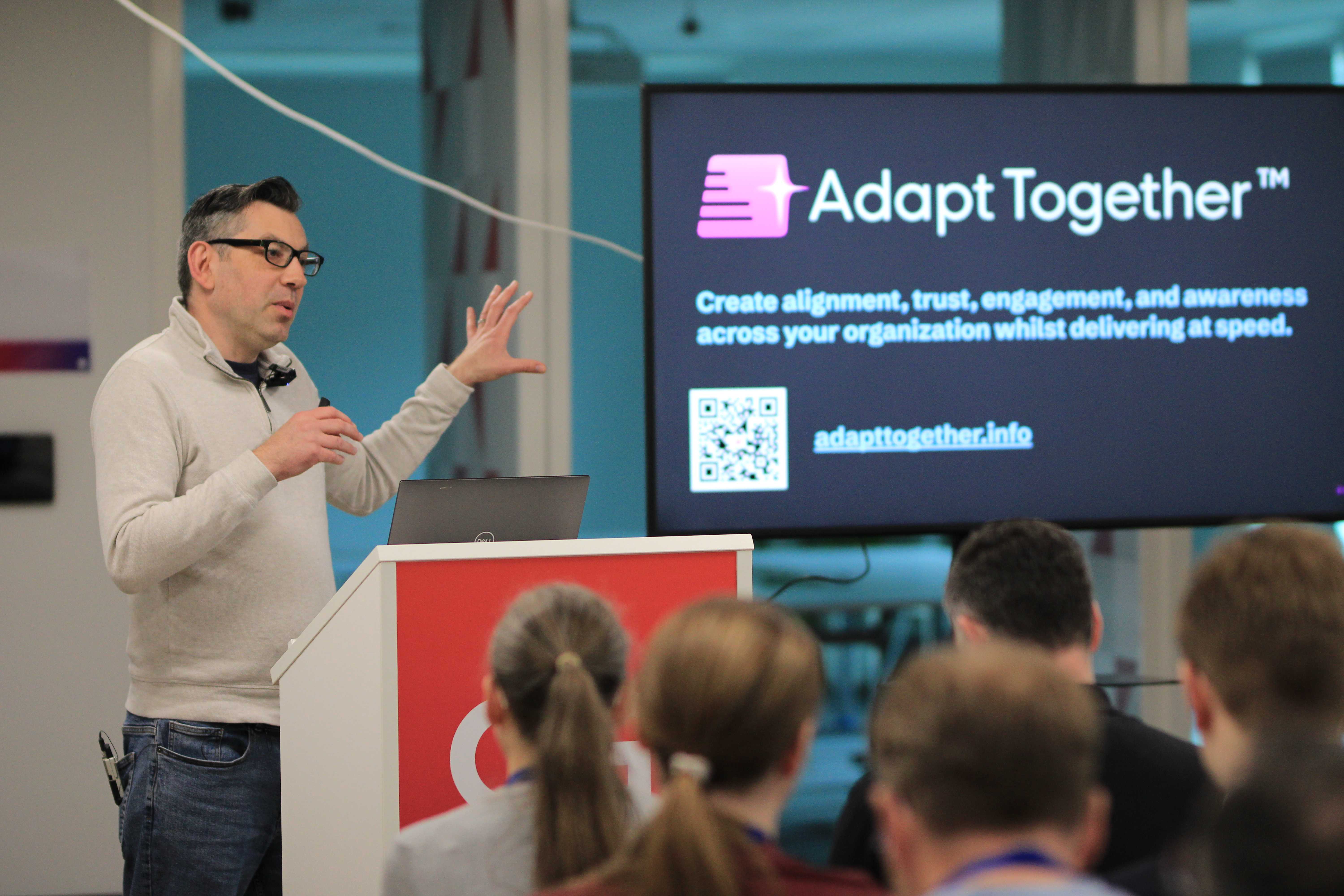 Speaker presenting Adapt Together at a community event