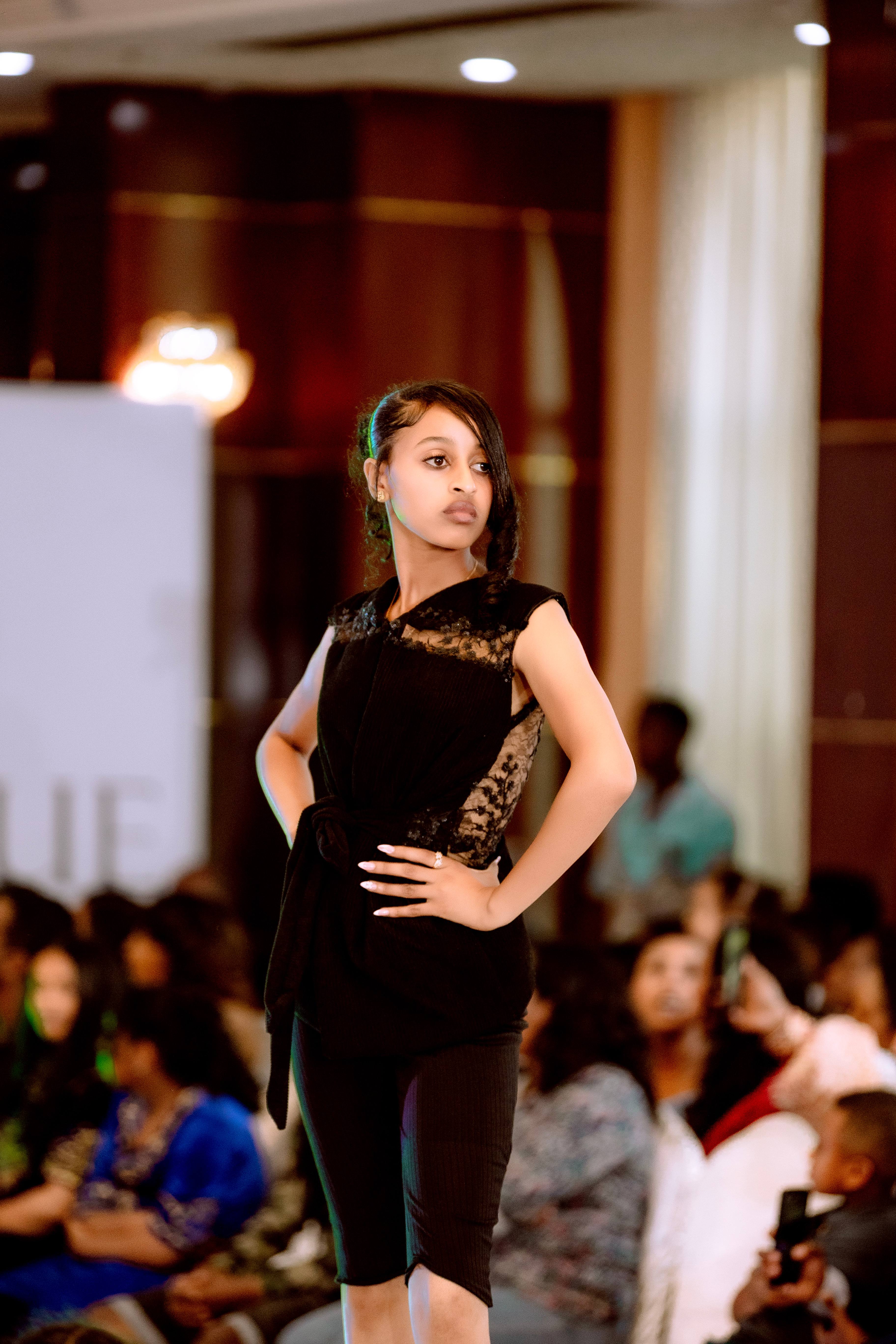 Model in a black lace look on a runway