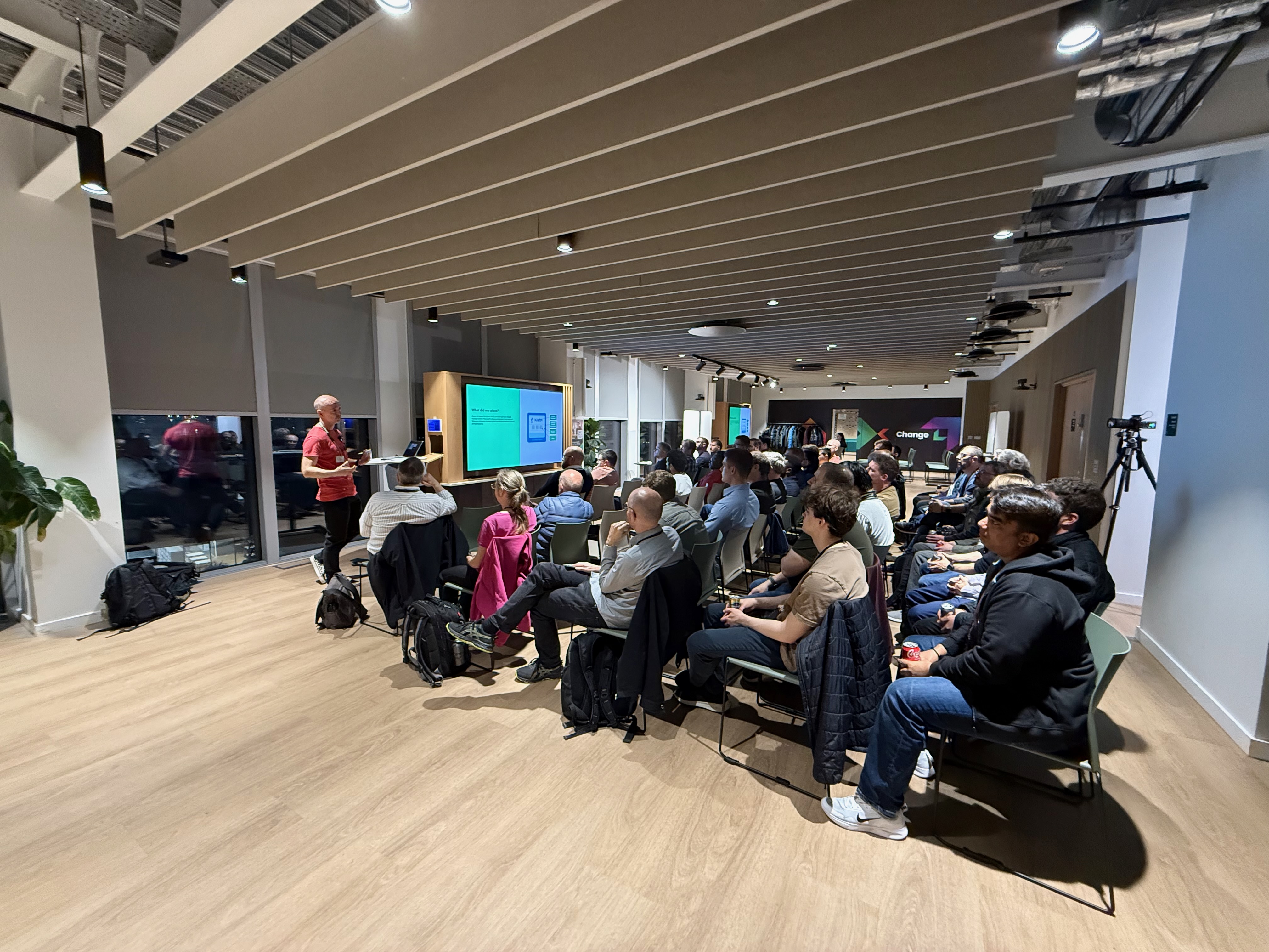 Speaker presenting at a modern venue with XChange branding