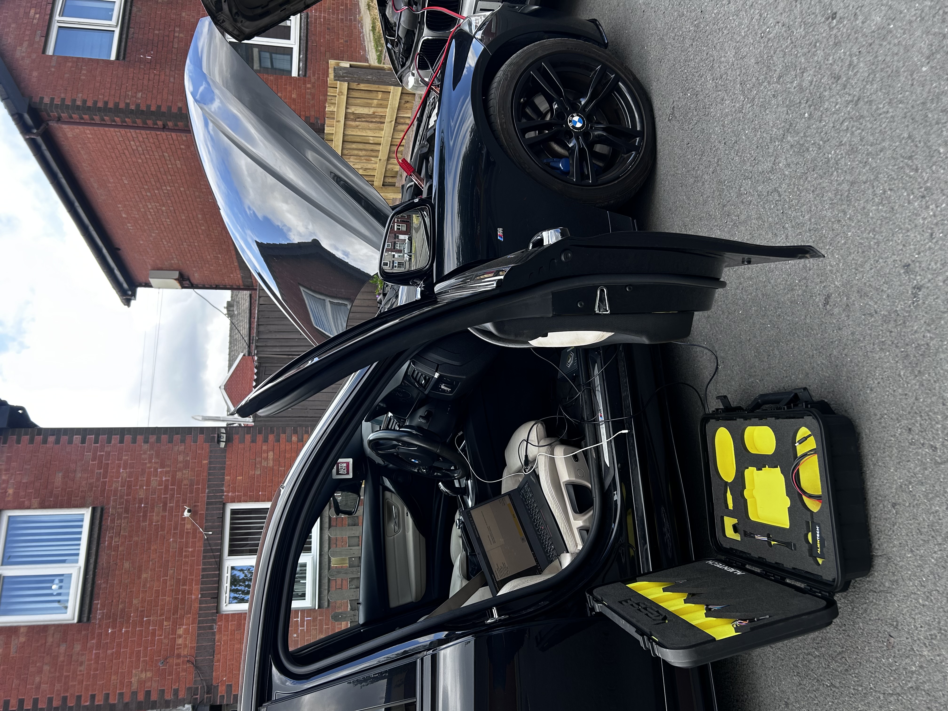 BMW 330d being programmed with diagnostic equipment during a mobile tuning appointment