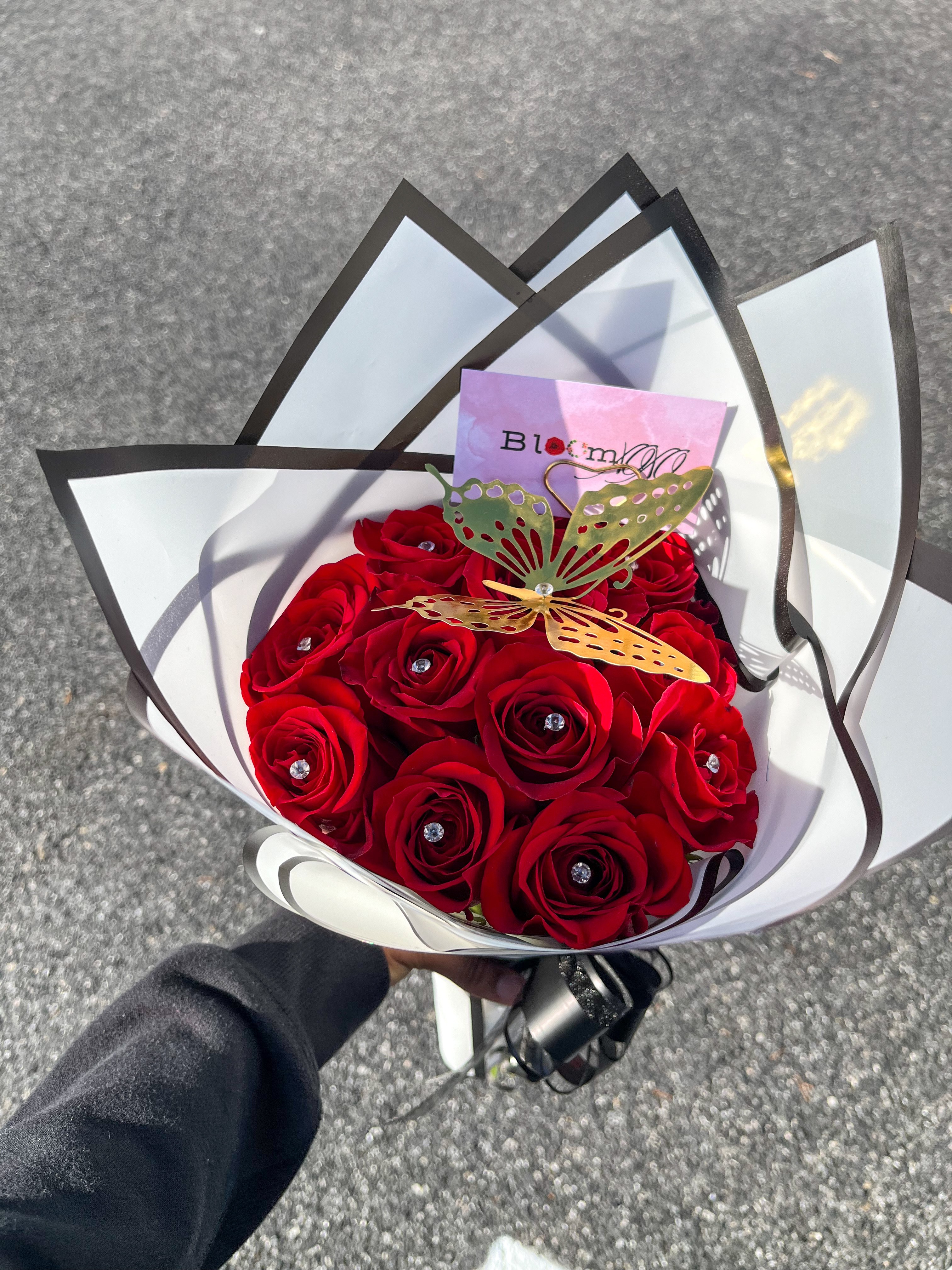 Red roses with butterfly in modern wrapping
