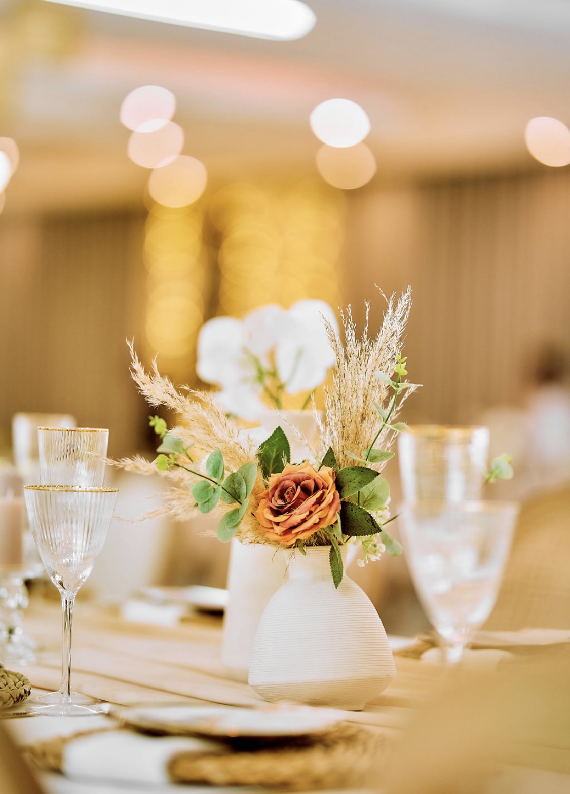 Warm floral table setting with an orange centerpiece